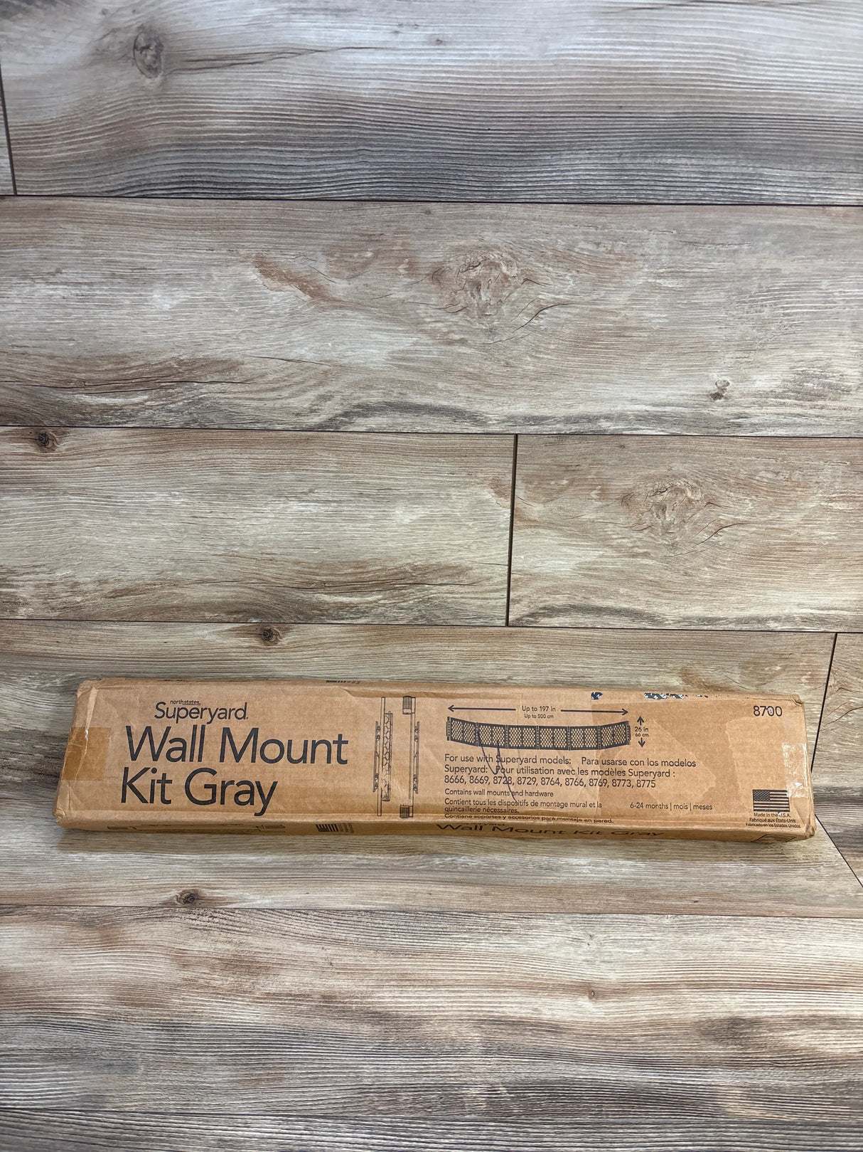 Superyard Wall Mount Kit Gray box on wood floor, kids safety gate accessory