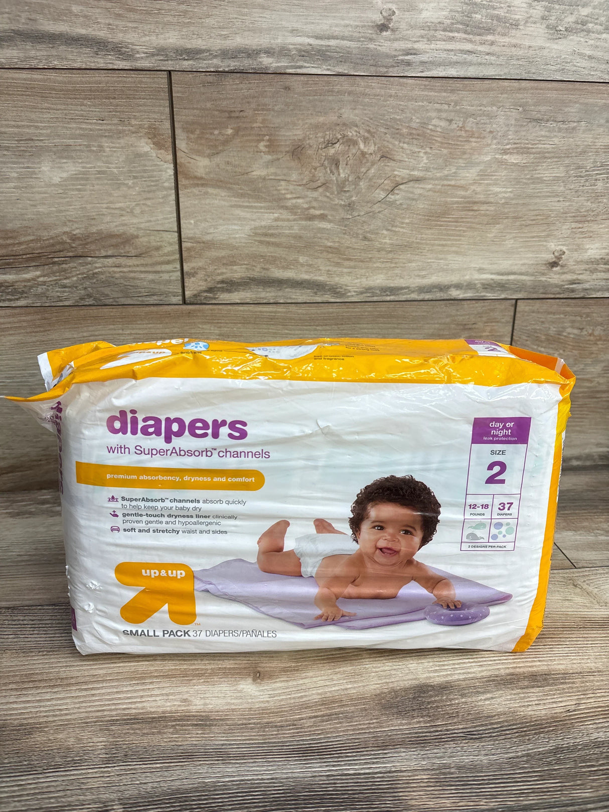 Package of Up & Up size 2 diapers with SuperAbsorb channels featuring baby on changing pad