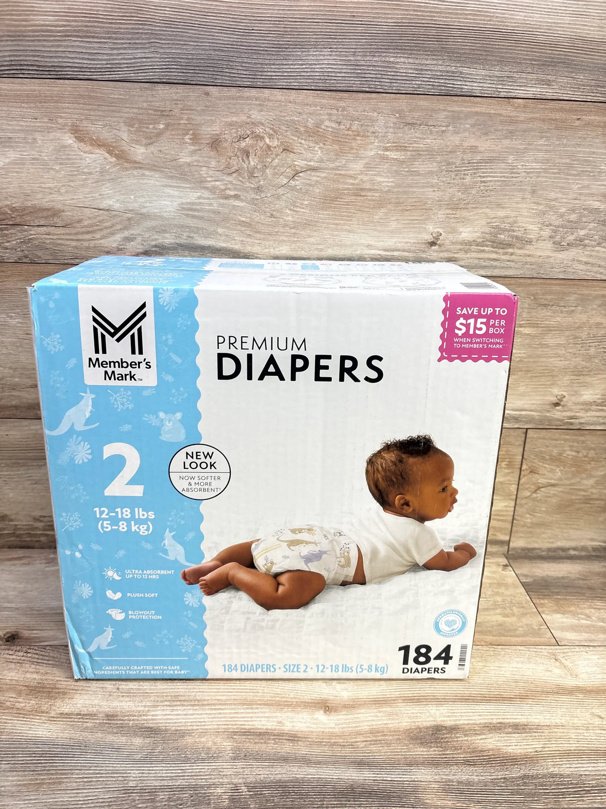 Front view of Member’s Mark Premium Diapers size 2 box showing 184 diapers, 12 to 18 lb range, and baby photo on wood floor