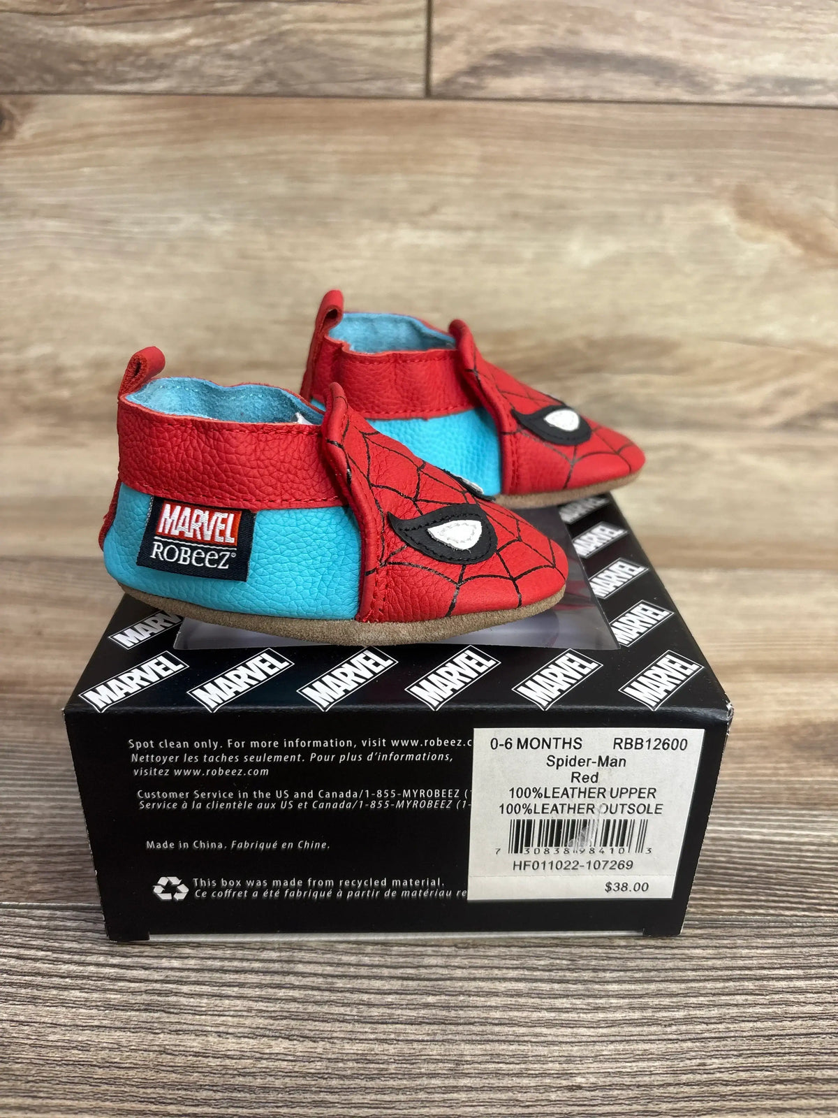 Red and blue Spider-Man themed leather baby shoes by Robeez for 0-6 months on Marvel branded box