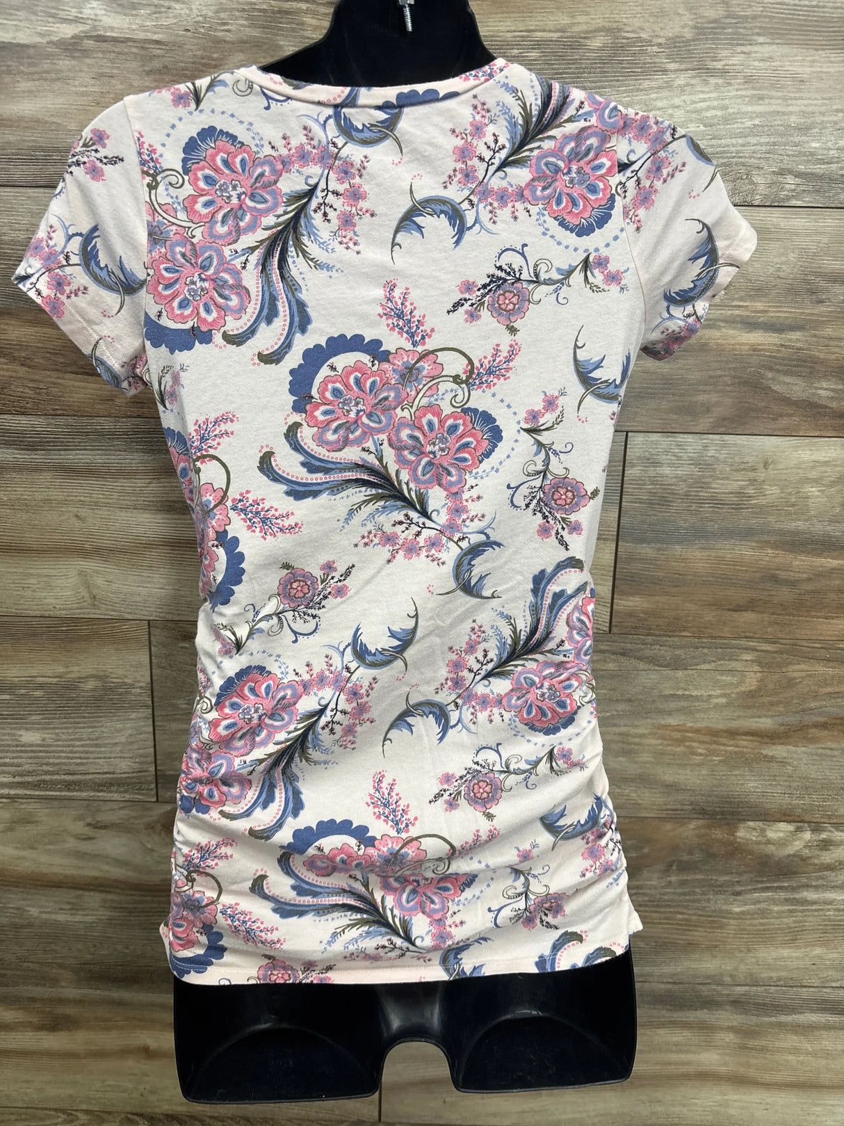 Pink and blue floral print girls' short sleeve shirt displayed on mannequin
