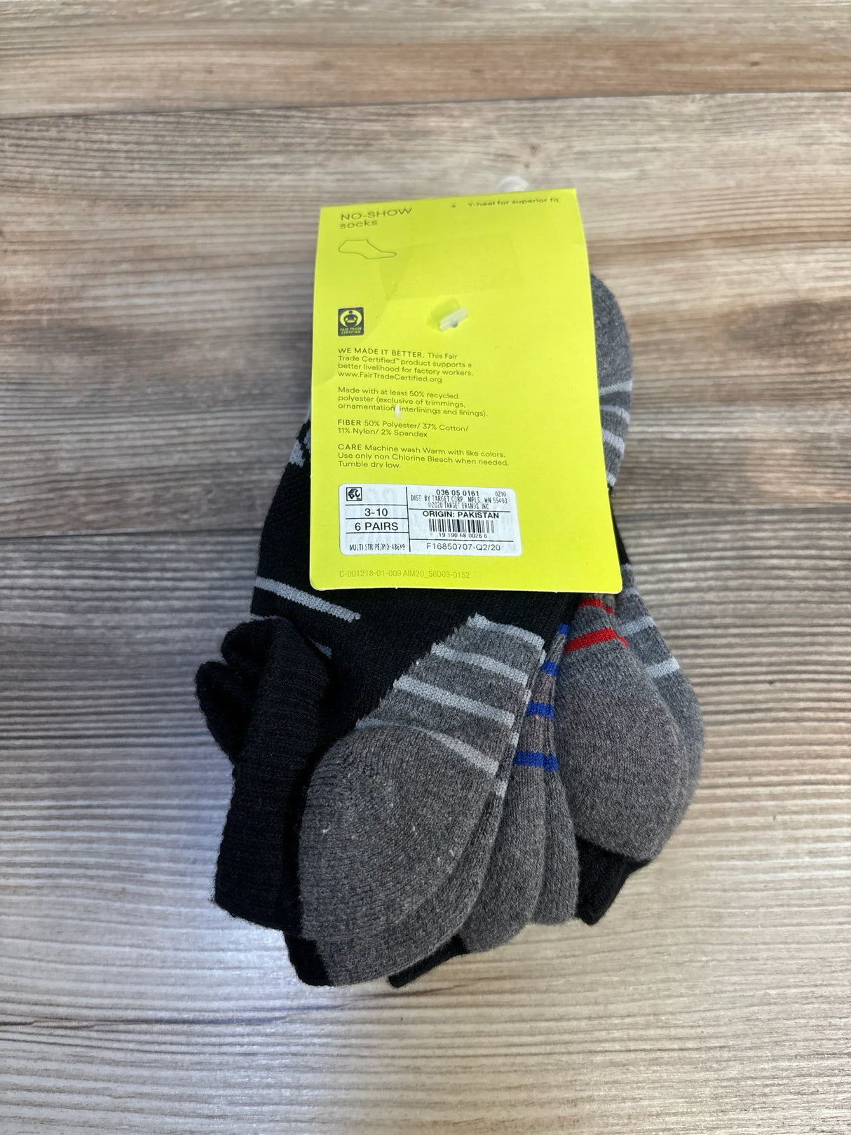 Pack of kids' no-show socks in assorted black and gray colors on wood background