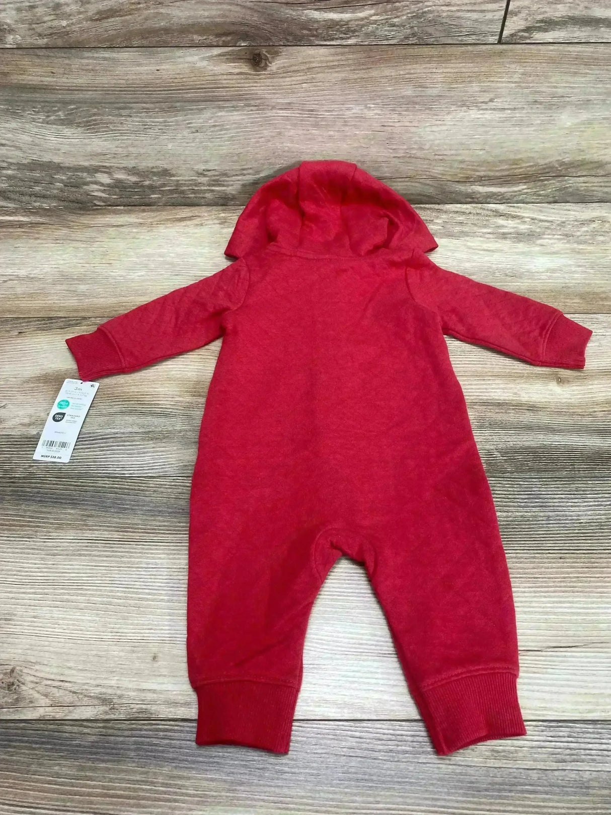 Flat lay of red Carter’s hooded baby jumpsuit, size 3M, back view showing long sleeves and ribbed cuffs on wood background