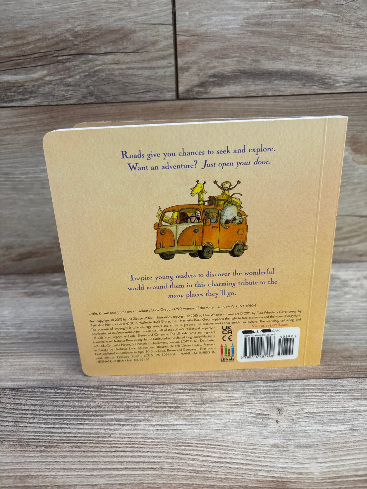 Back cover of Wherever You Go board book with an orange car carrying animal passengers and an adventure message