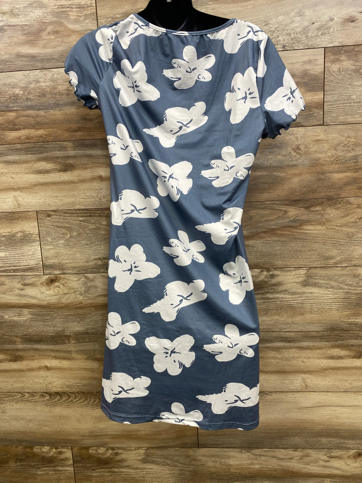 Back view of Ekouaer maternity button-up nightgown showing oversized white floral print, ruffled short sleeves, on wooden plank background