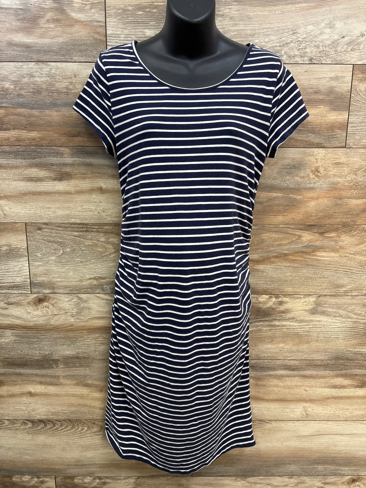 Navy blue and white striped short sleeve dress on mannequin, wood background