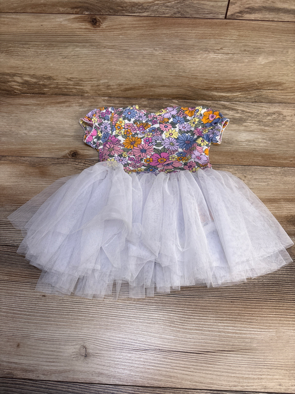 Floral print baby dress with white tulle skirt, perfect for toddler parties or special occasions.
