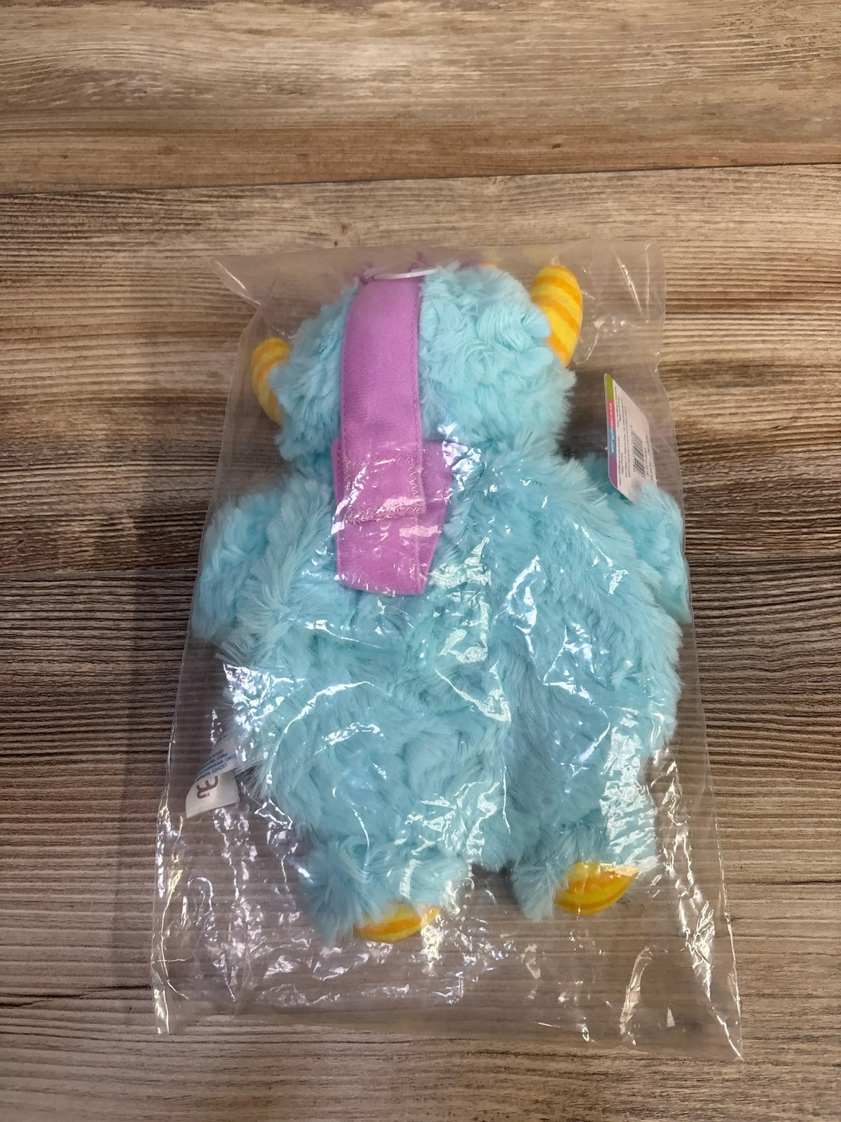 Rear view of NEW ebba Baby Talk Story Pals Monster Moods Plush Book with blue furry monster and purple crinkly storybook