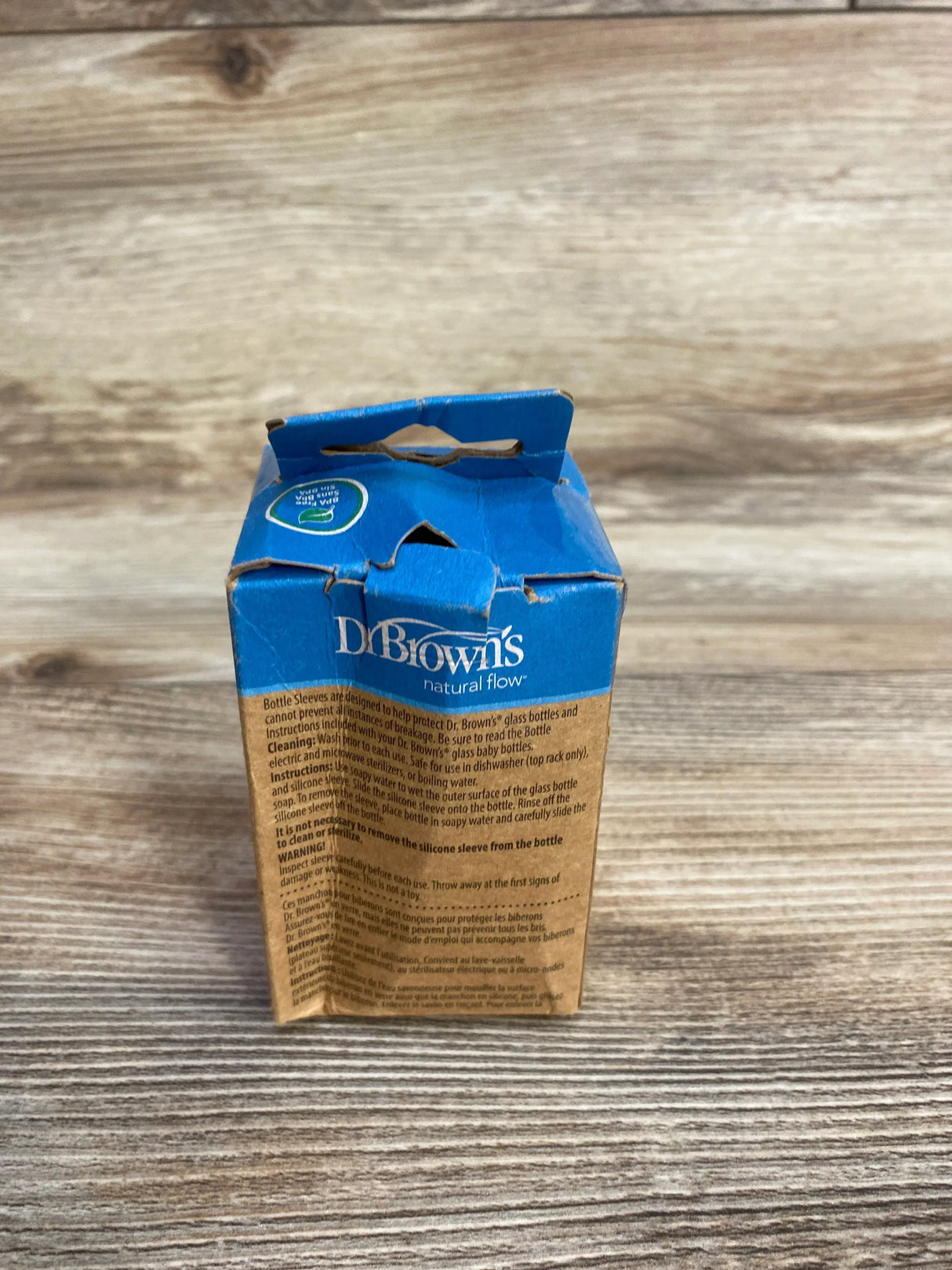 Dr. Brown's Natural Flow bottle sleeve packaging on a wooden surface