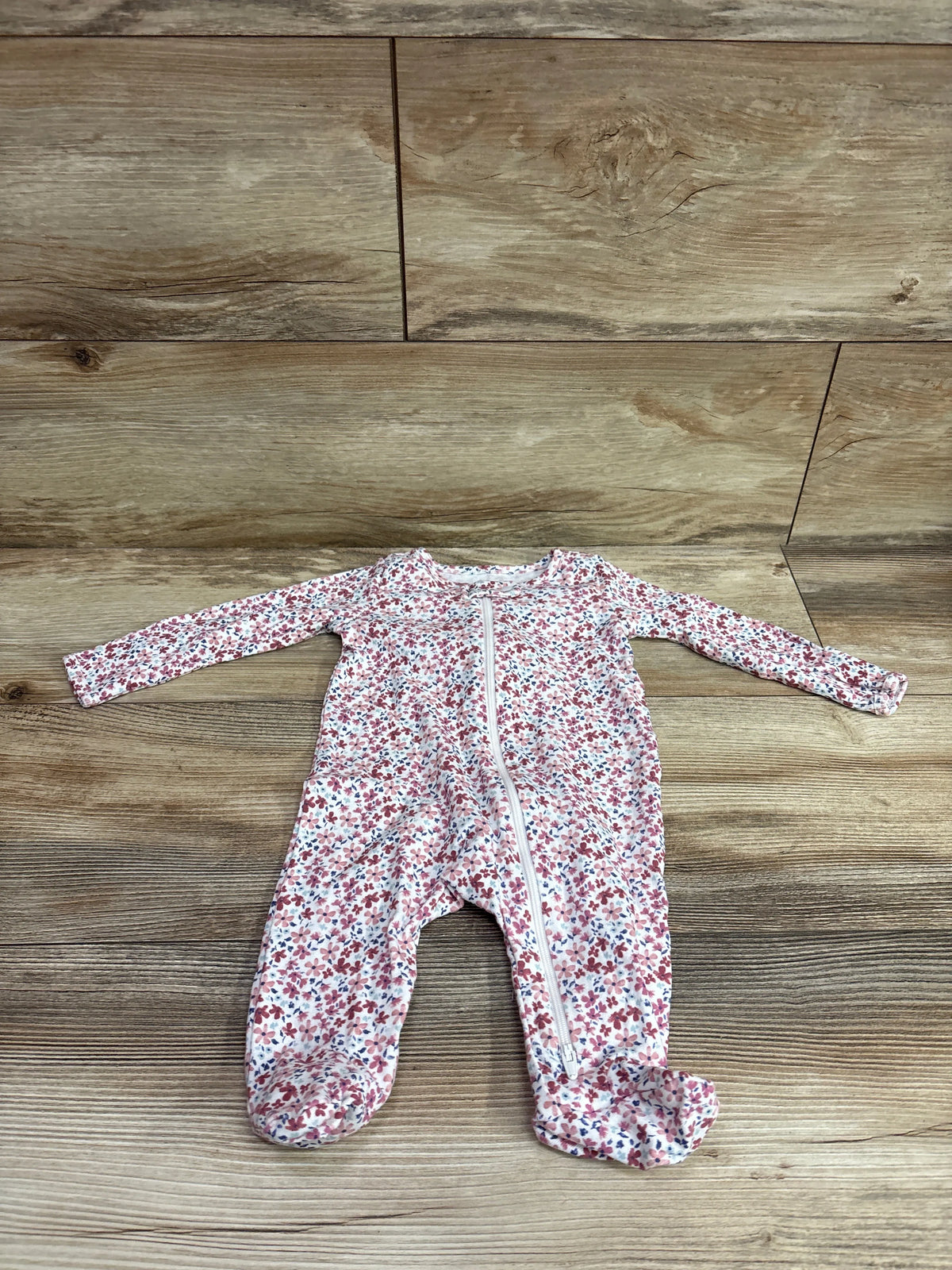 Front view of Just One You white size 3m sleeper showcasing floral print, long sleeves, footed legs, and front zipper