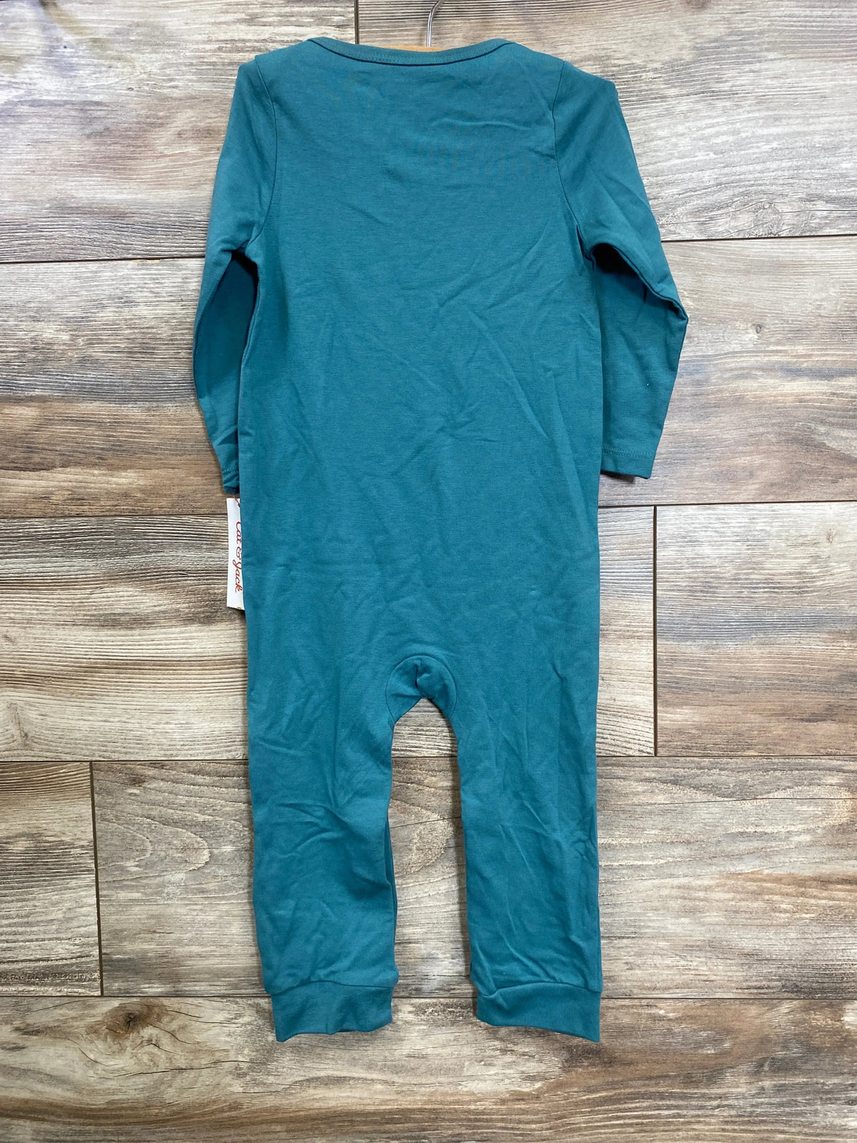 Teal long sleeve baby romper laid flat on wood floor, children's clothing resale