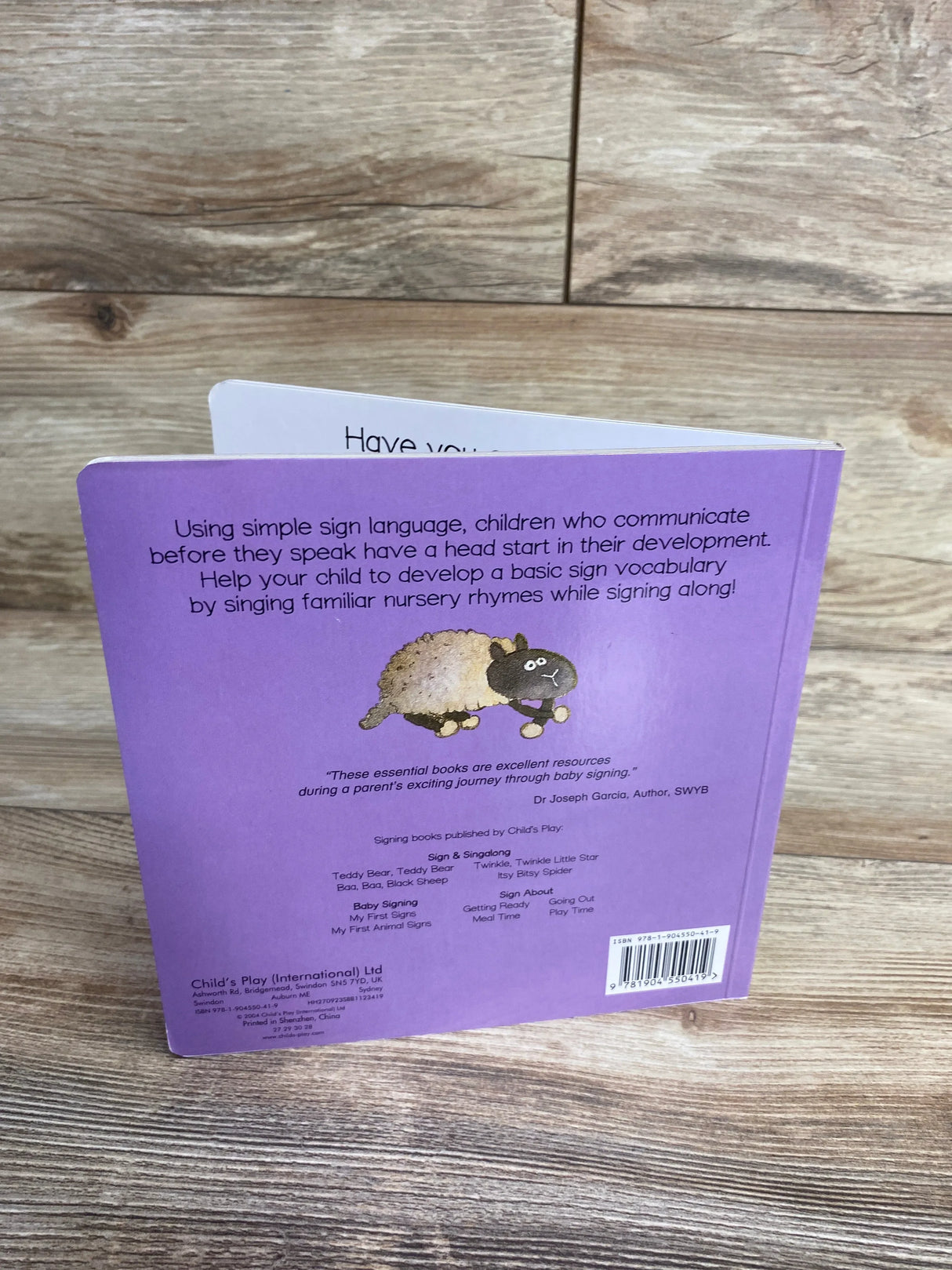 Back of Sign and Sing Along Baa Baa Black Sheep board book, purple cover with sheep illustration and sign language blurb