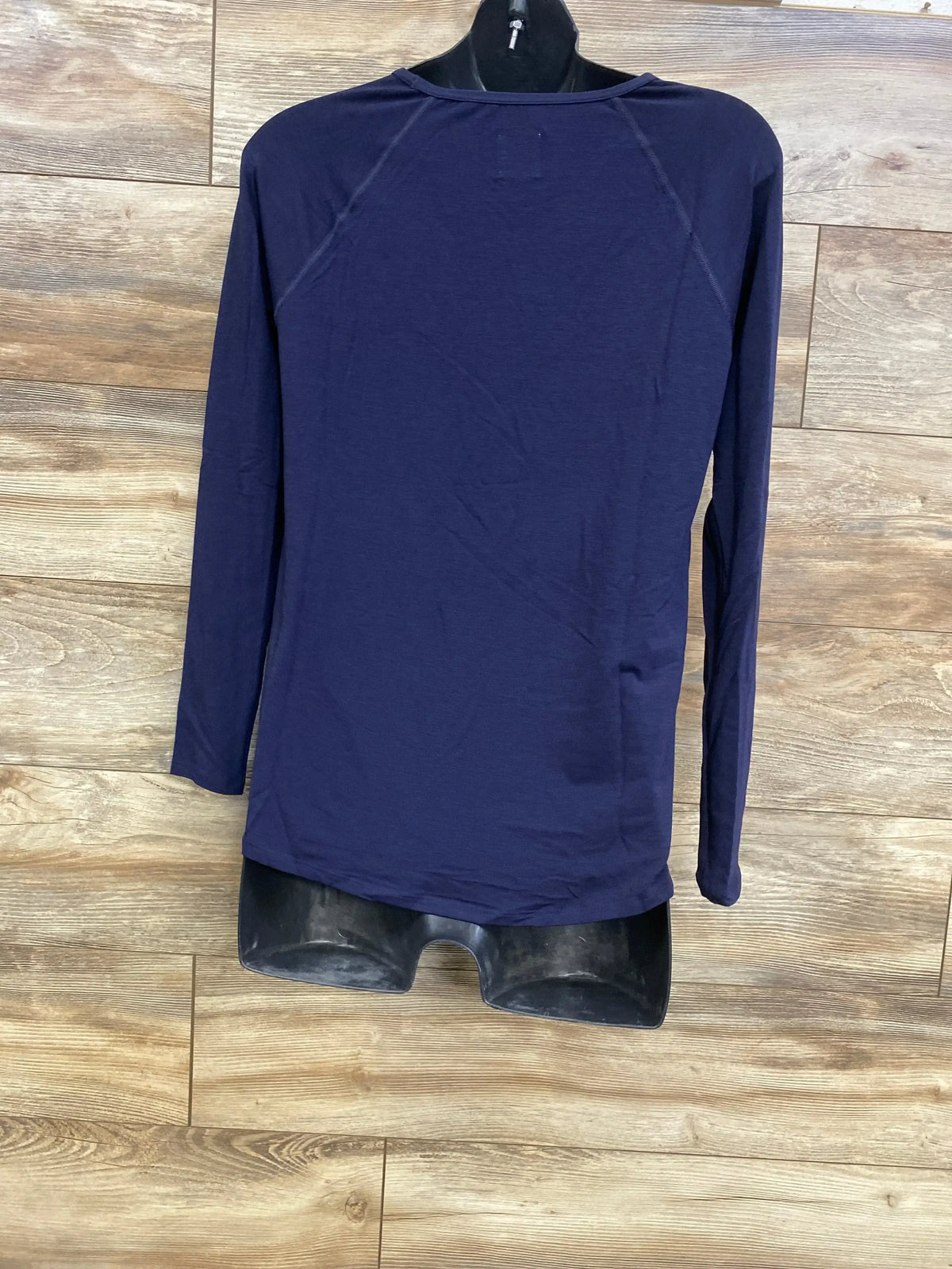 Front view of navy Gap maternity long-sleeve shirt on a mannequin showing raglan seams, crewneck, and curved hem