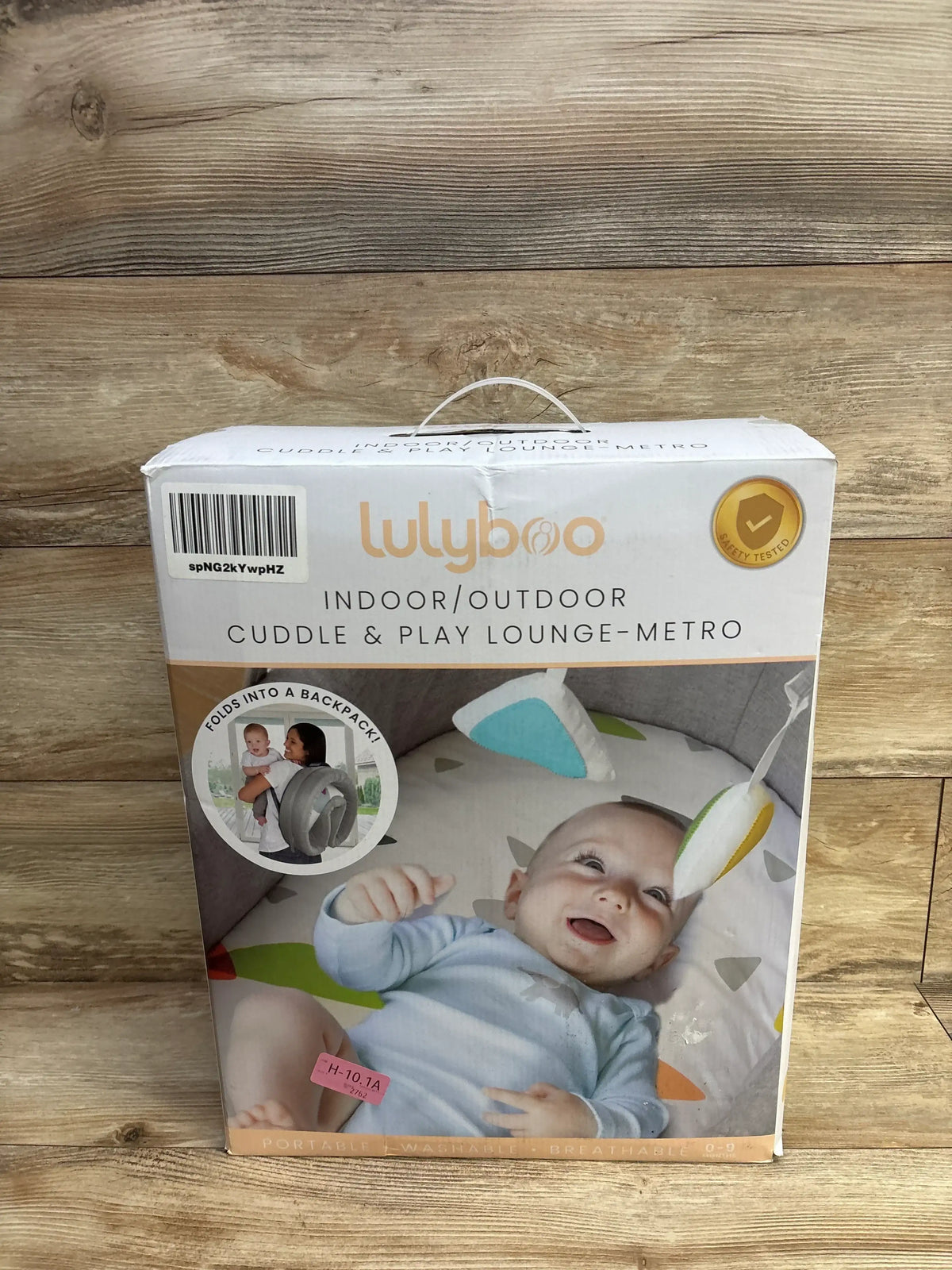 Lulyboo cuddle and play lounge portable baby lounger box with smiling infant on package