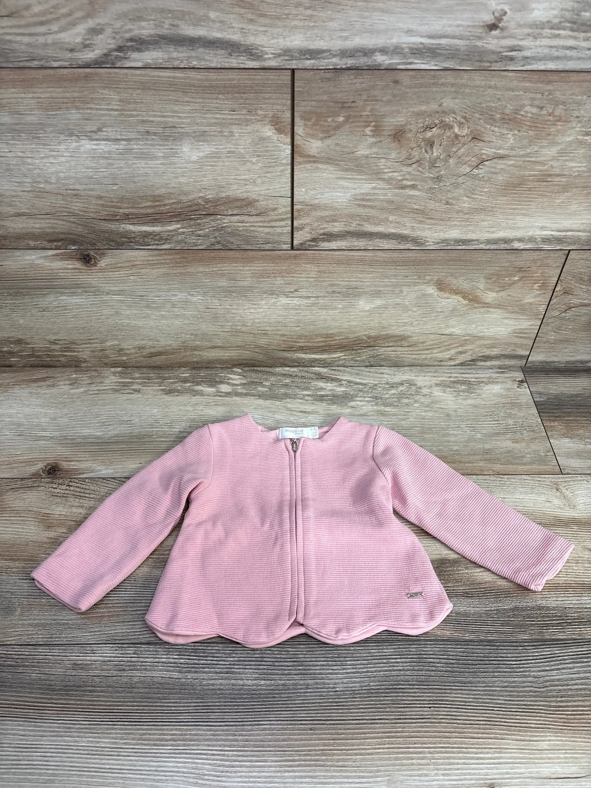 Pink baby jacket with zipper on wood floor, long sleeves, toddler outerwear fashion