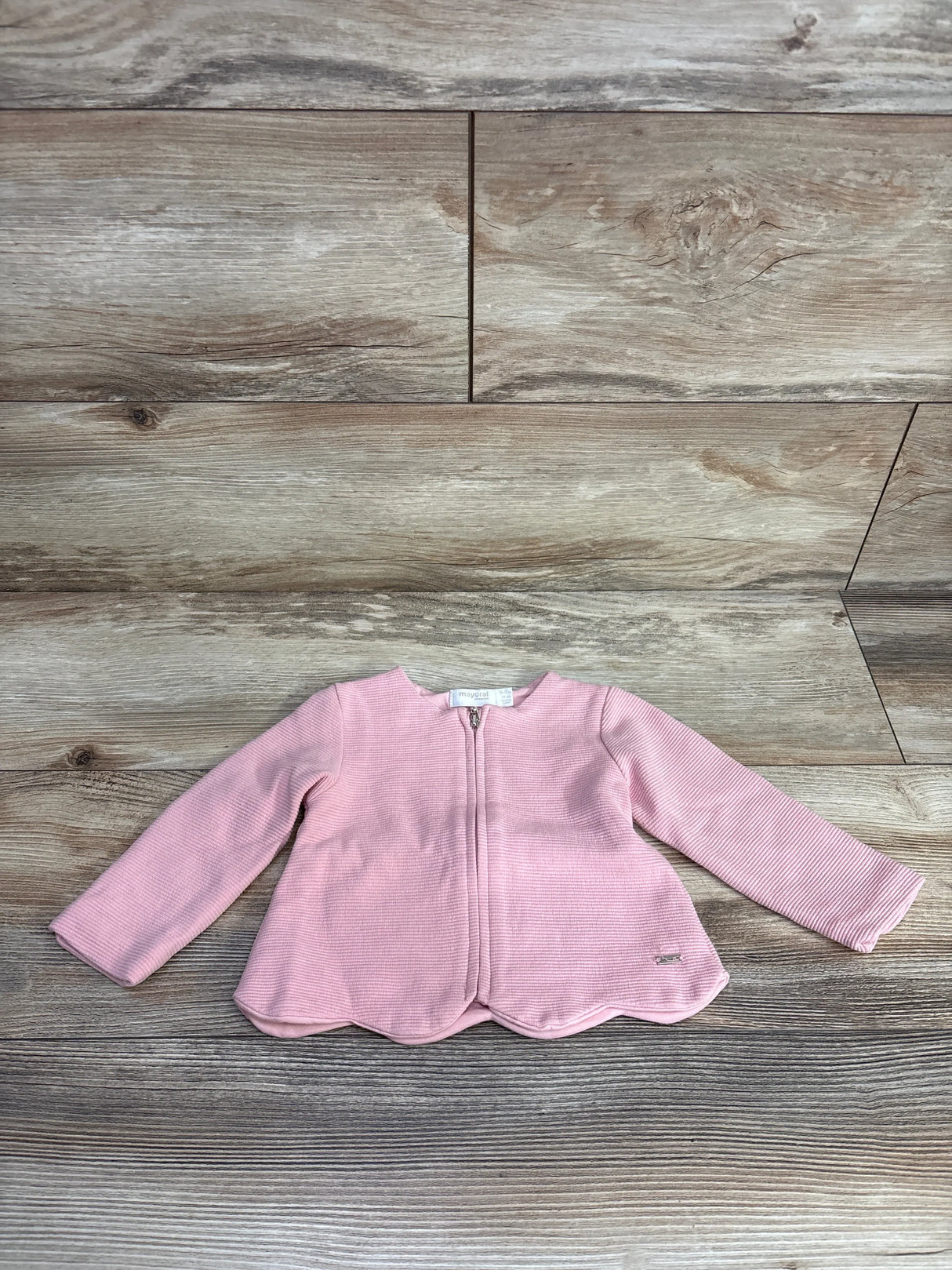 Pink baby jacket with zipper on wood floor, long sleeves, toddler outerwear fashion