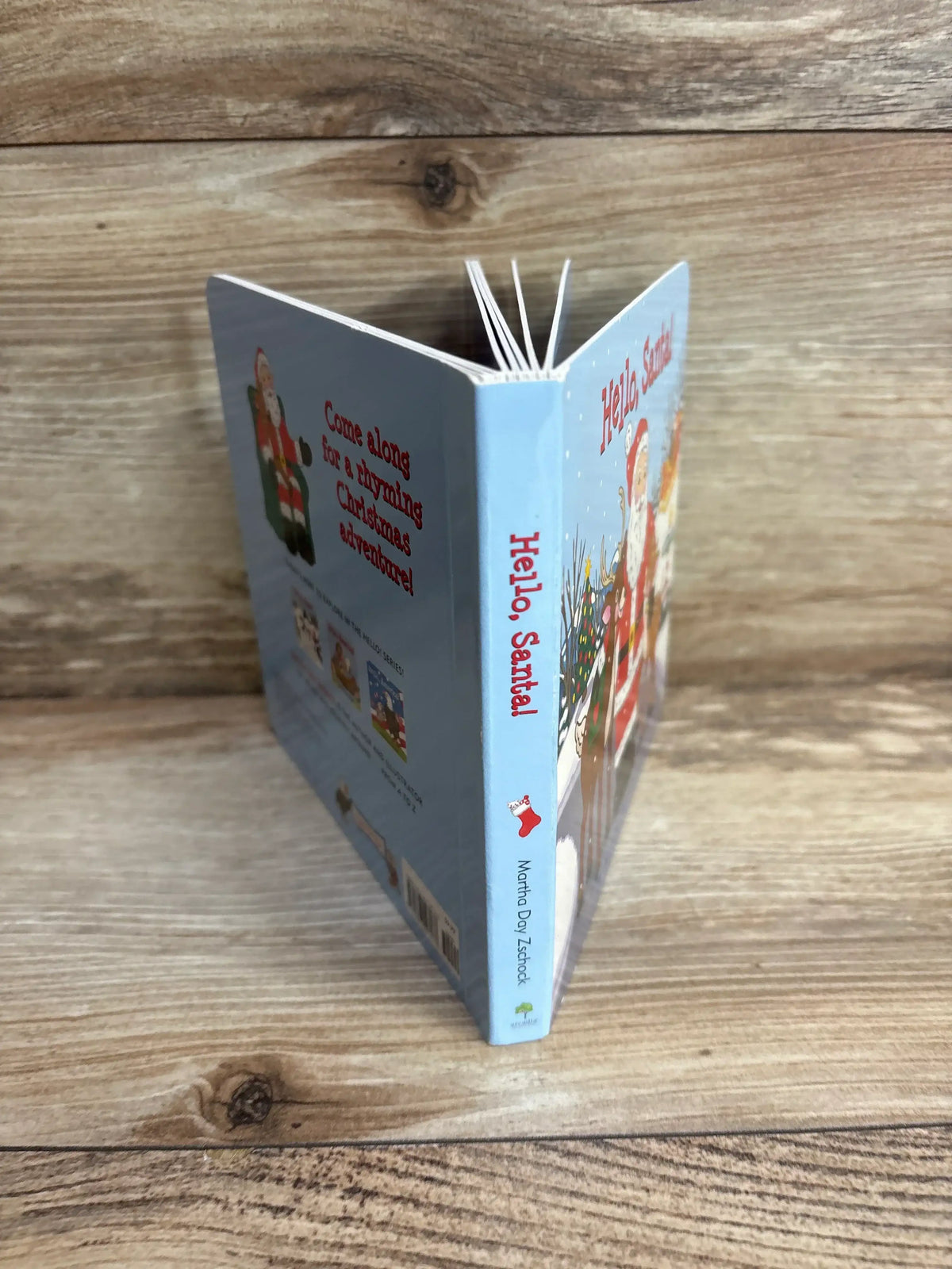 Hello, Santa! children's Christmas book with festive illustrations on wooden surface