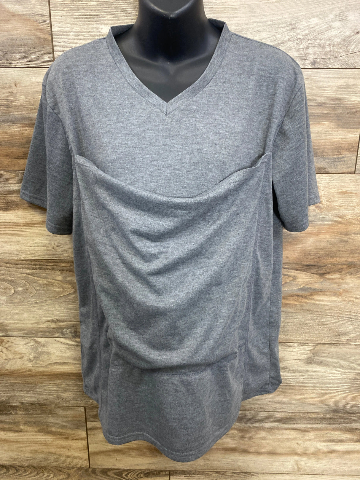 Gray short sleeve maternity nursing shirt with v-neck on mannequin, wooden background