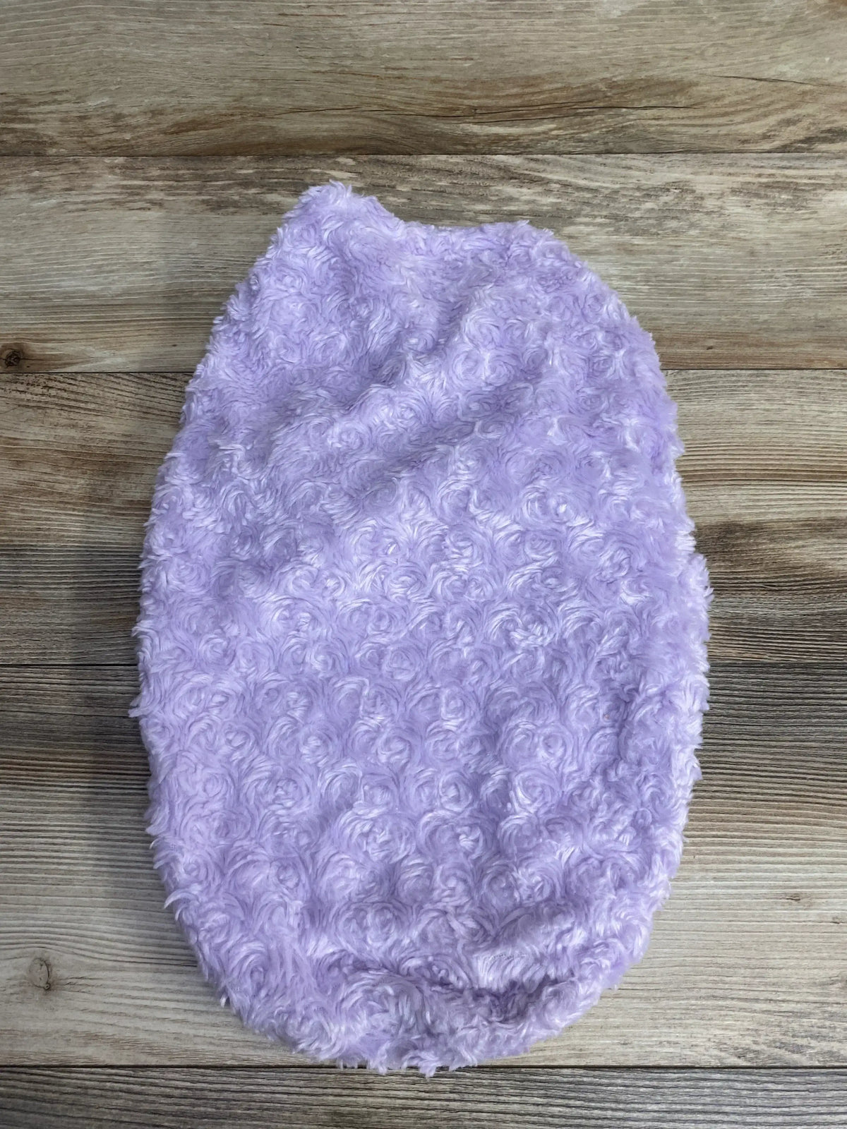 Top view of Blankets & Beyond Rosette Swaddle Wrap in lilac showcasing curly rosette texture on a wood-look floor