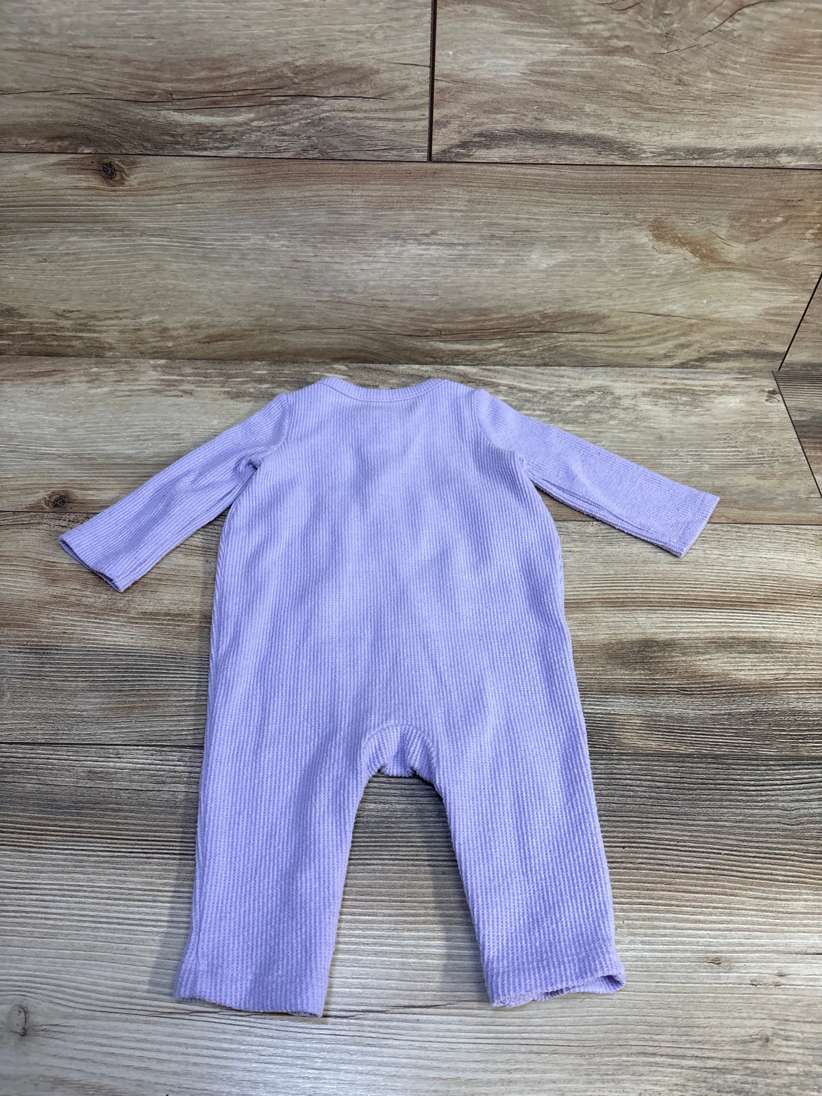 Flat lay back view of Cat and Jack waffle knit henley coverall in purple showcasing ribbed texture on wood background