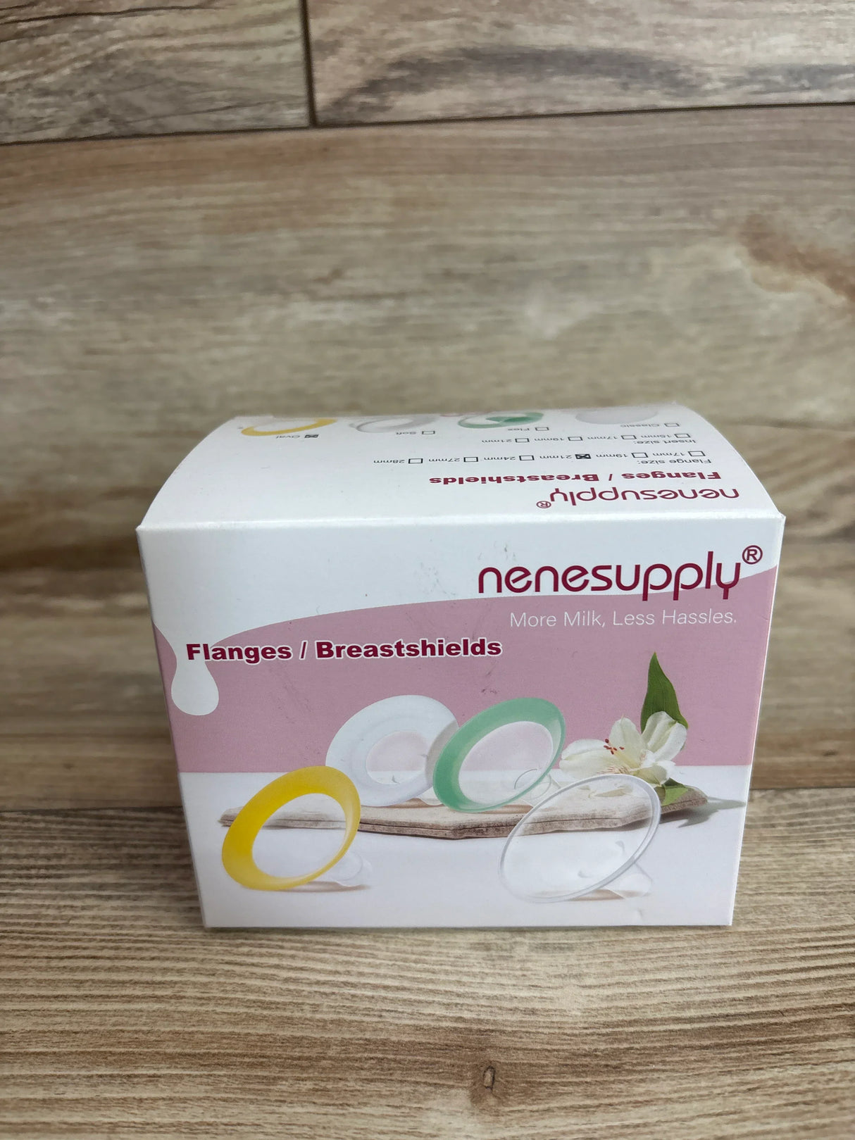 Front view of Nenesupply 21mm oval flange box showing colorful flange illustrations on a wood tabletop