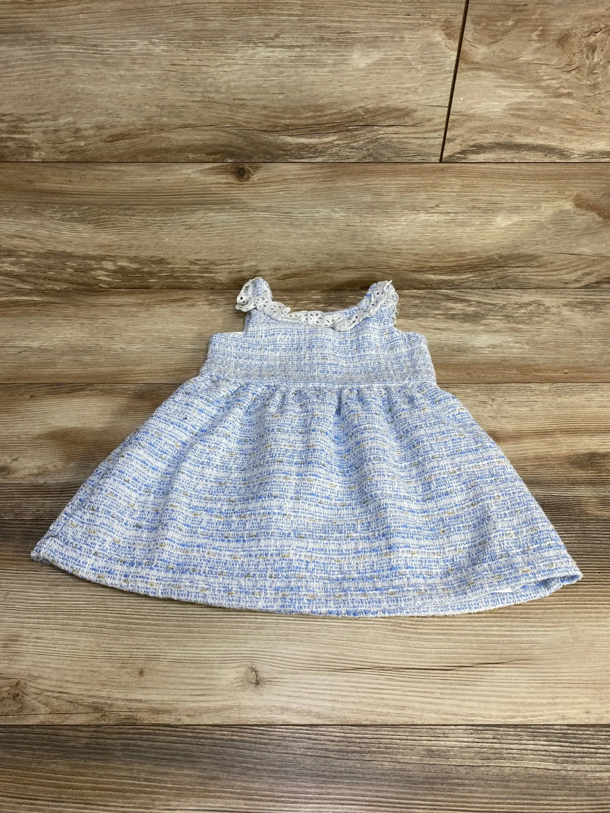 Flat-lay front of Janie and Jack blue tweed toddler dress size 2T showing eyelet ruffle neckline and gathered skirt on wood