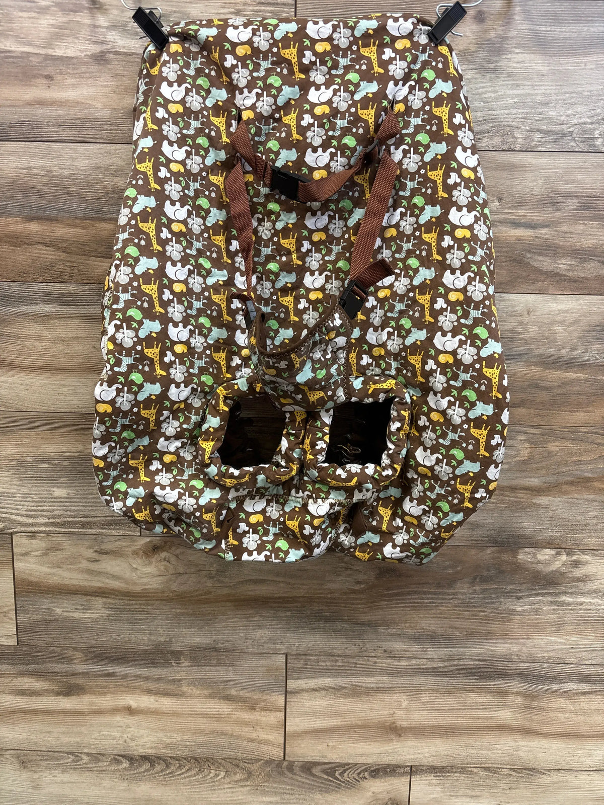 Top view of brown Heather and Heart two in one shopping cart and high chair cover with animal print, straps, and leg openings