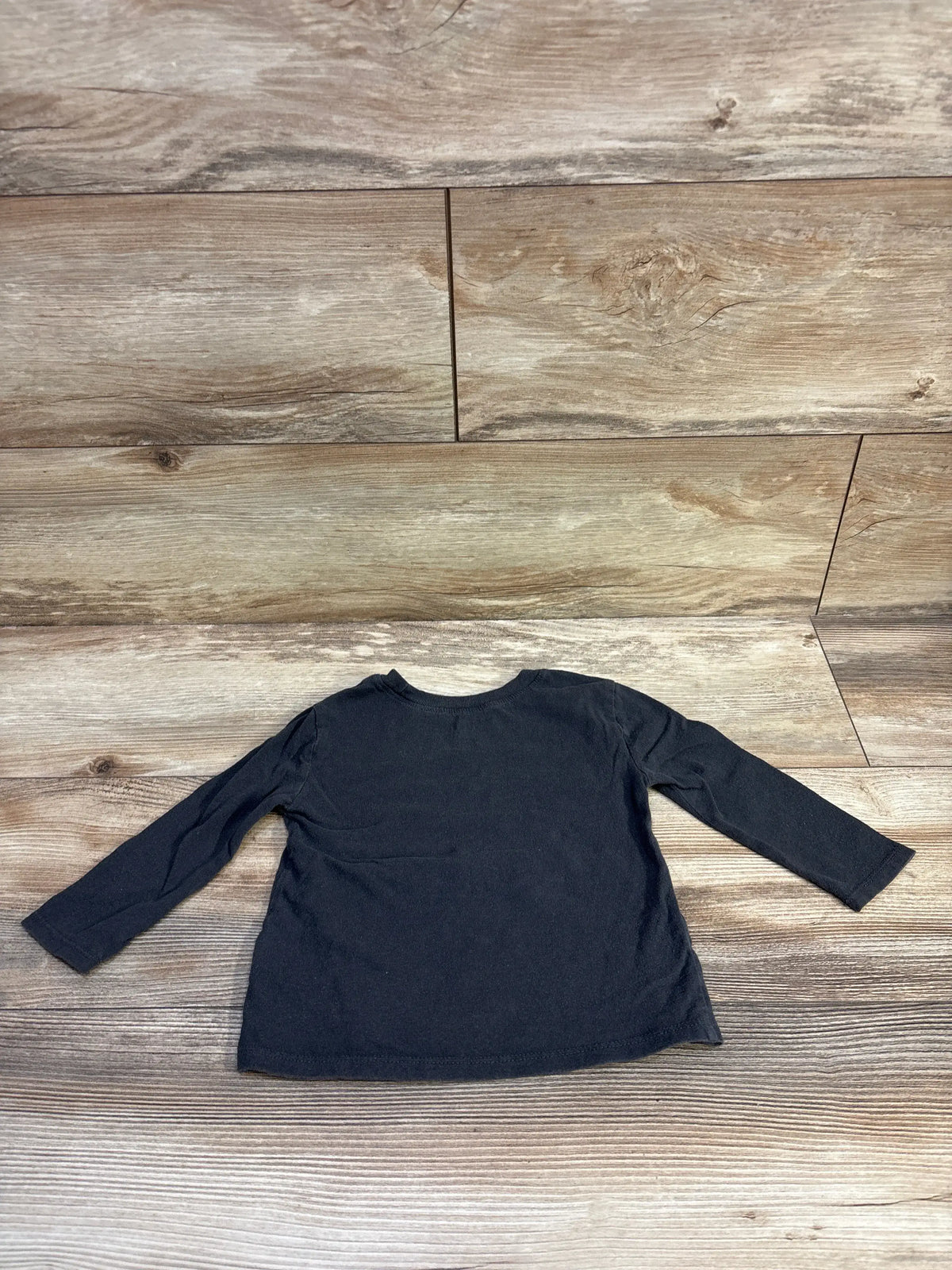 Back view of Old Navy Grateful Dead shirt showing long sleeves and relaxed fit on a wood-look floor