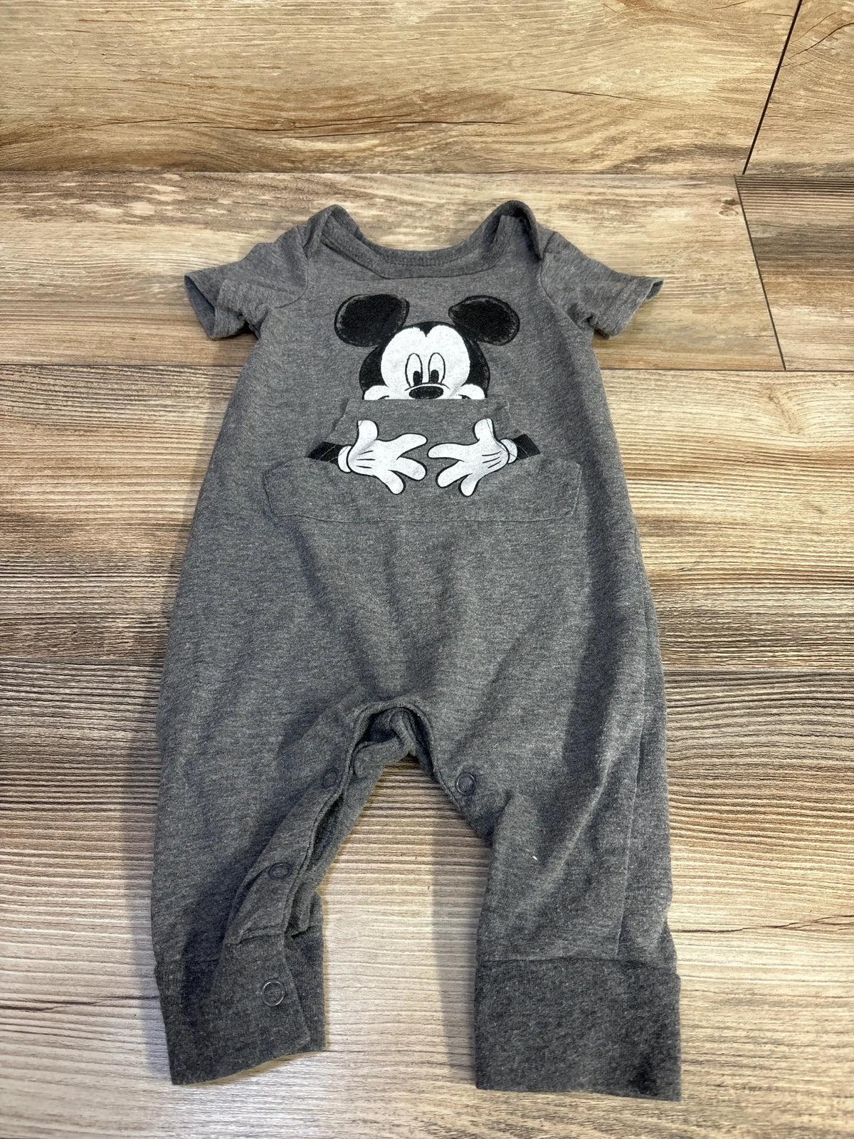 Front view of grey Disney Baby Mickey Mouse jumpsuit (3–6 months) showing Mickey graphic and front snap closures on white background