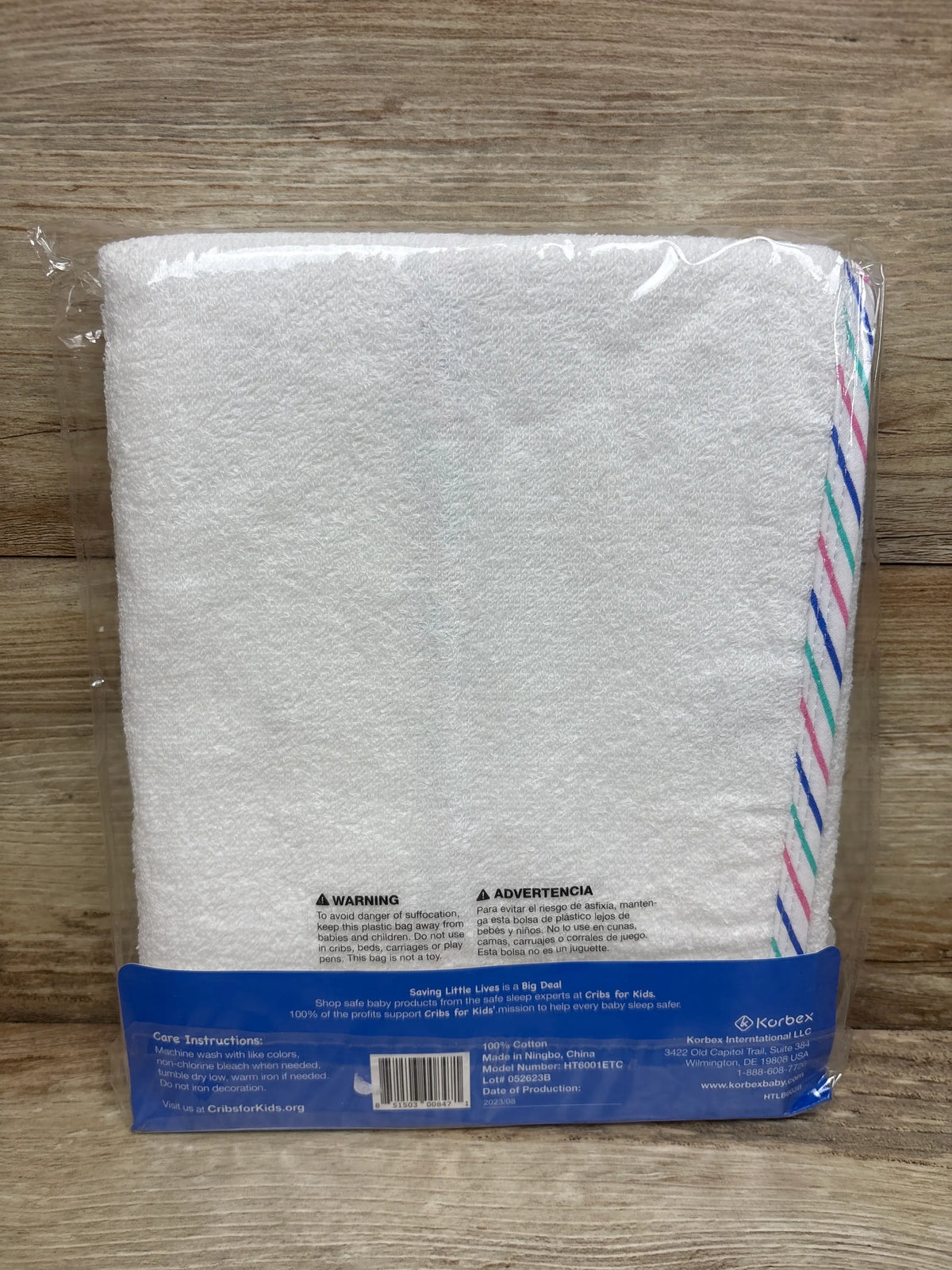 Front view of ette cetera 3pc hooded towel set by Cribs for Kids showing white towels with multicolor trim in packaging