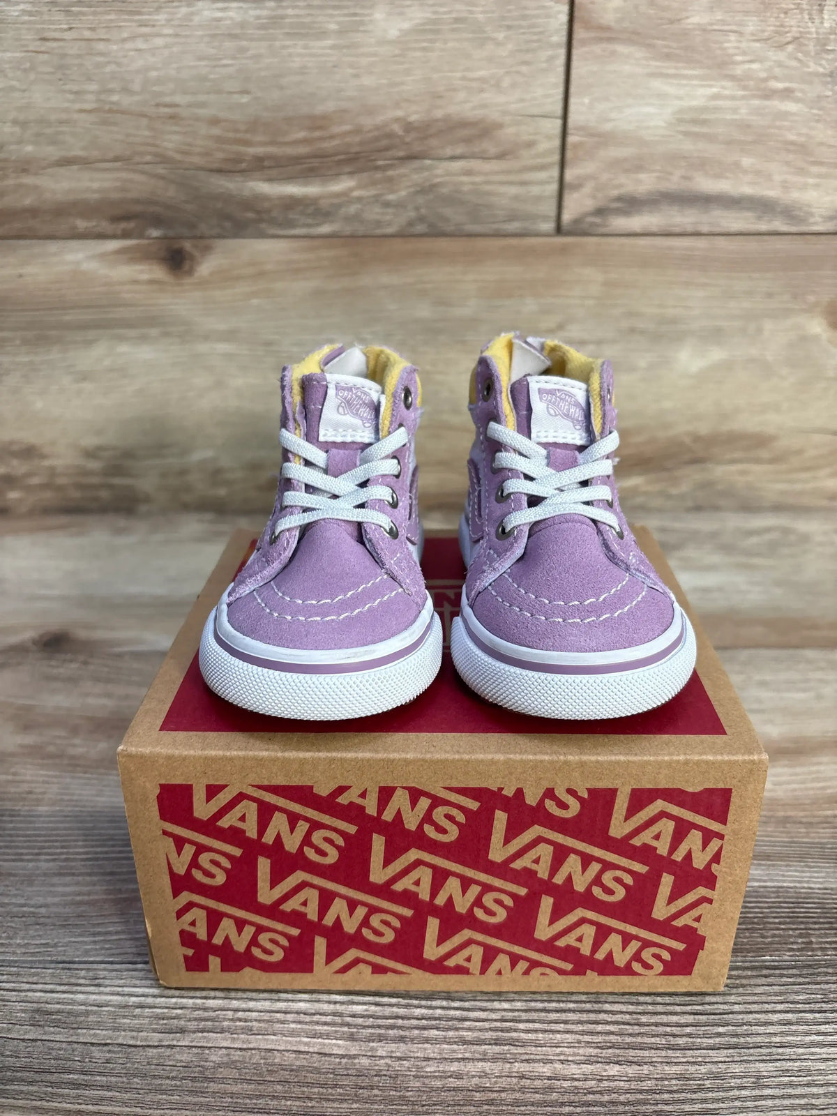 Front view of purple Vans MTE Sk8 Hi-Zip toddler sneakers showcasing white laces and rubber soles on a Vans shoebox