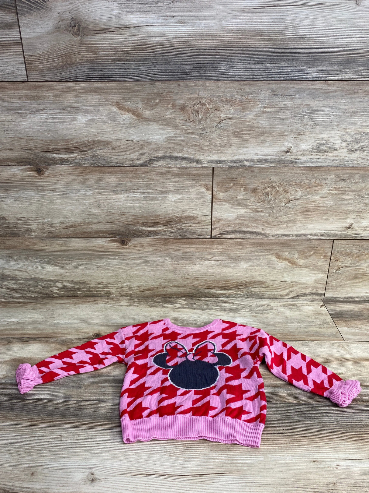 Pink and red houndstooth kids sweater with Minnie Mouse silhouette and bow detail