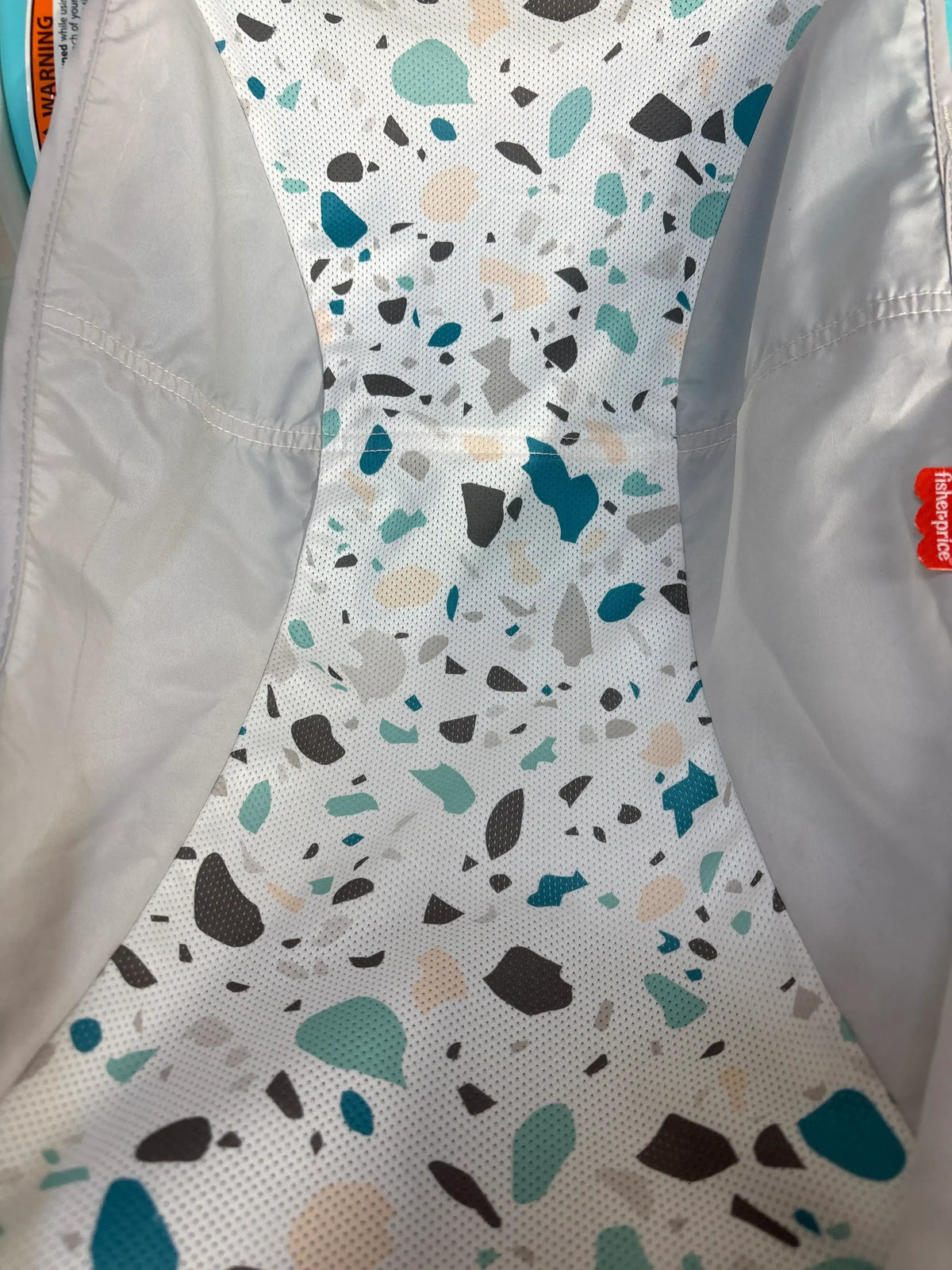 Close-up of the terrazzo print mesh fabric inside a Me n Mommy To Be baby bath tub.