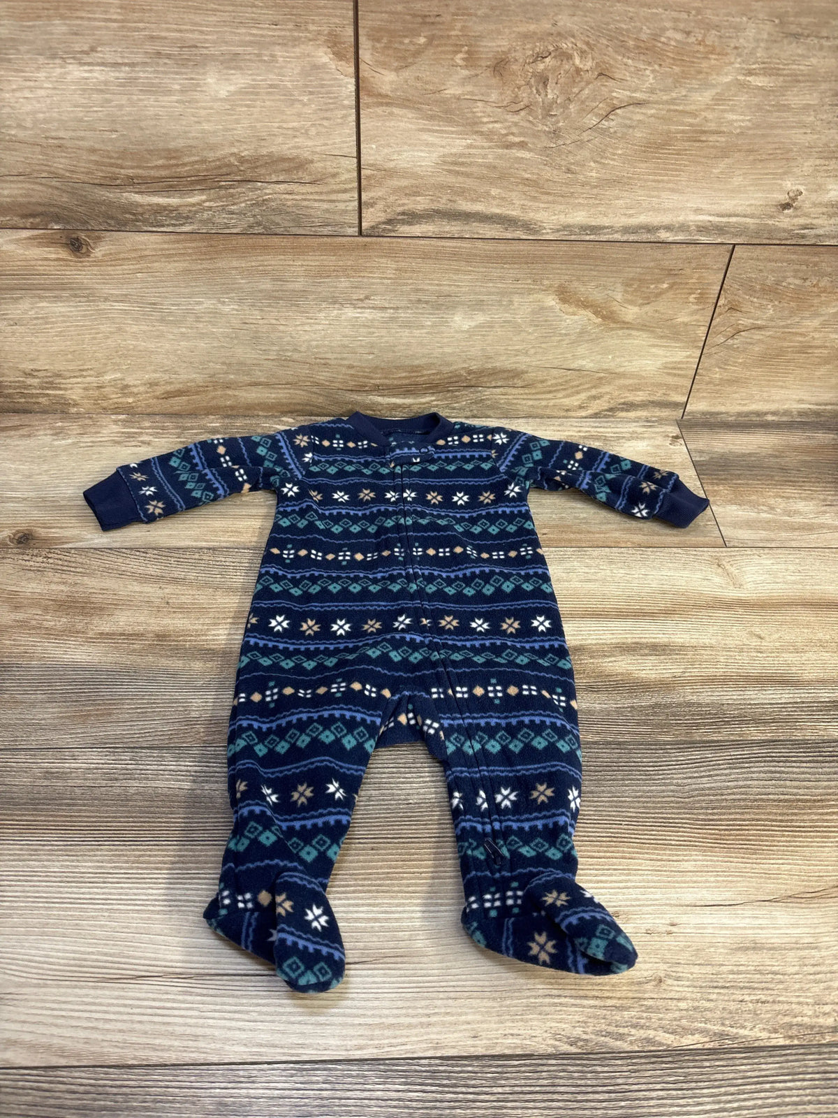 Front view of Carter’s blue blanket sleeper showcasing patterned fabric and covered feet on a wood-look floor