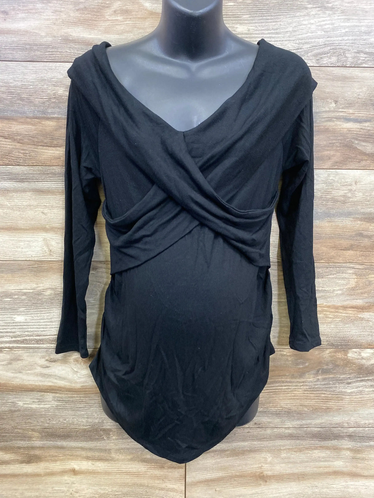 Black long sleeve maternity top with crisscross front detail on mannequin