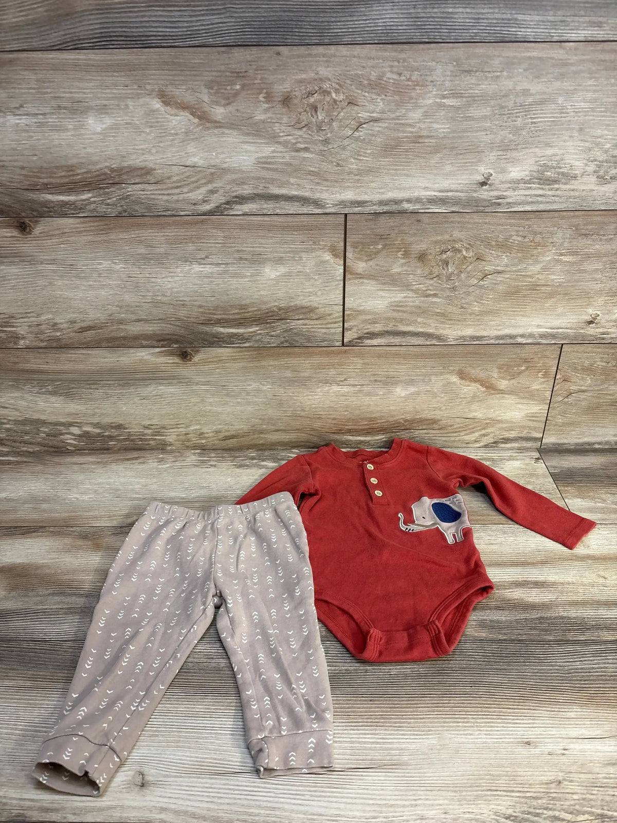 Infant outfit set with red long-sleeve bodysuit featuring elephant and beige patterned pants