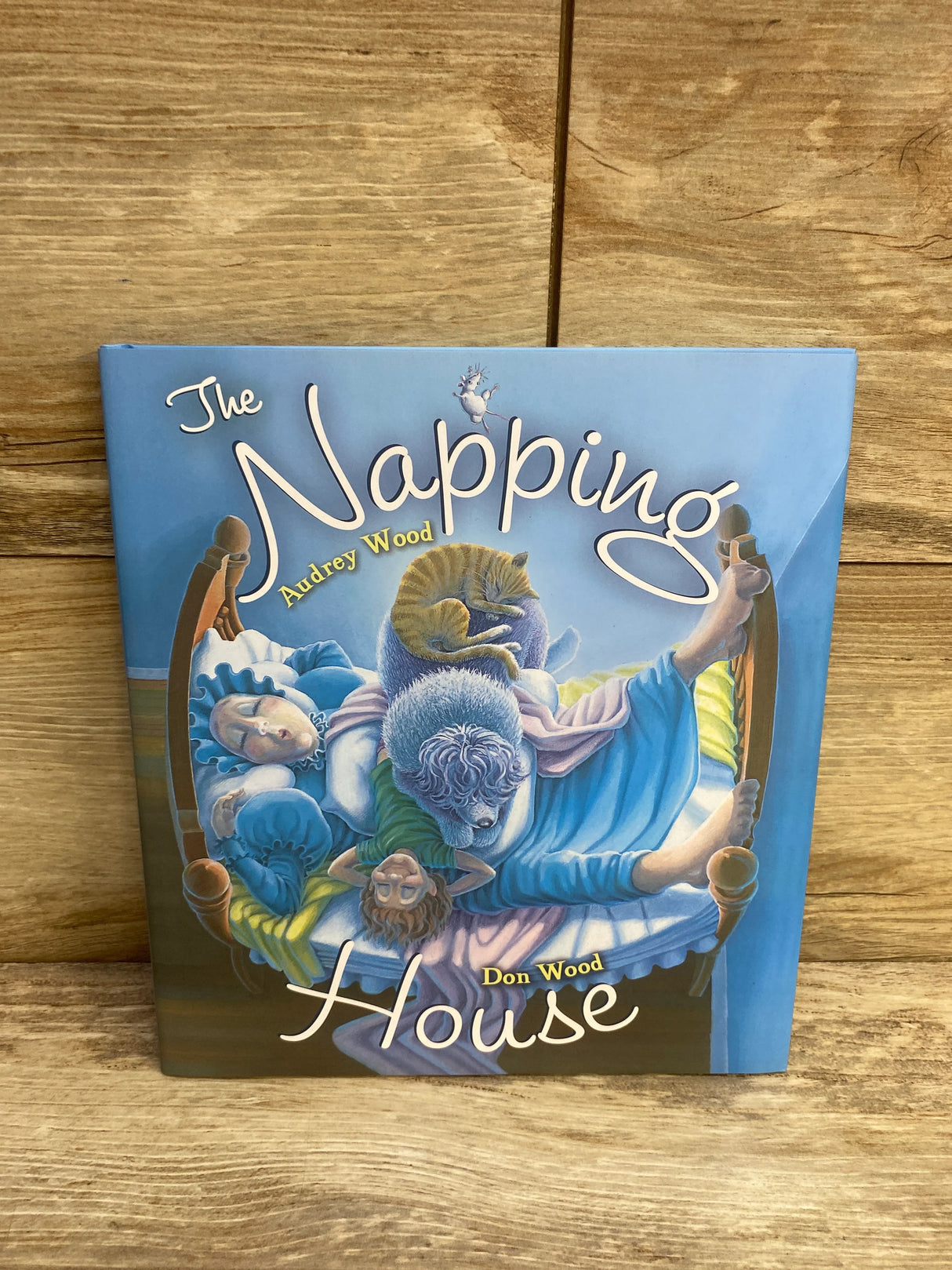 The Napping House book cover with illustrations of sleeping people and animals on a bed