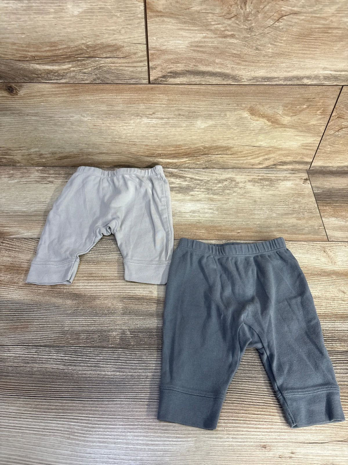 Top-down view of Cloud Island 2pk pull-on pants in light and dark grey with elastic waistbands and cuffed ankles