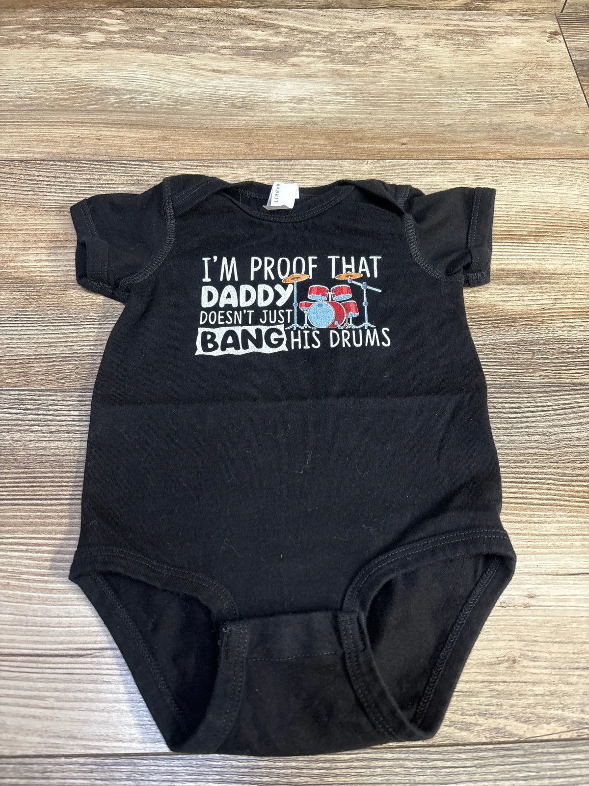 Black Rabbit Skins baby bodysuit with drum graphic and funny text about daddy's drumming.