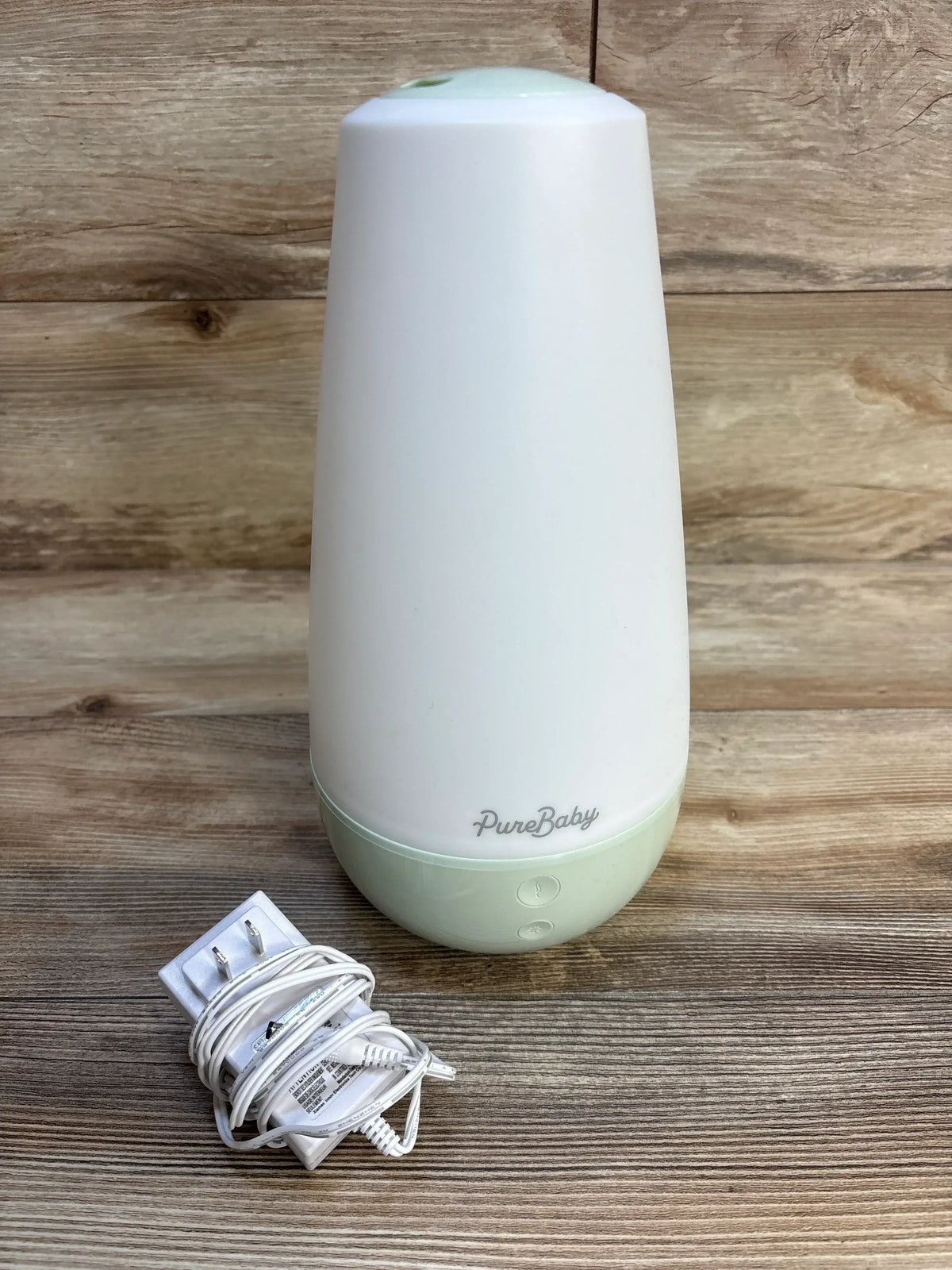 PureBaby humidifier with power cord on wooden surface, ideal for baby nurseries and maternity care