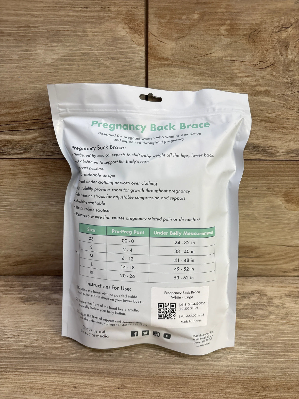 Back of Pregnancy Back Brace packaging showing headline, size chart, instructions and size Large sticker on wood background