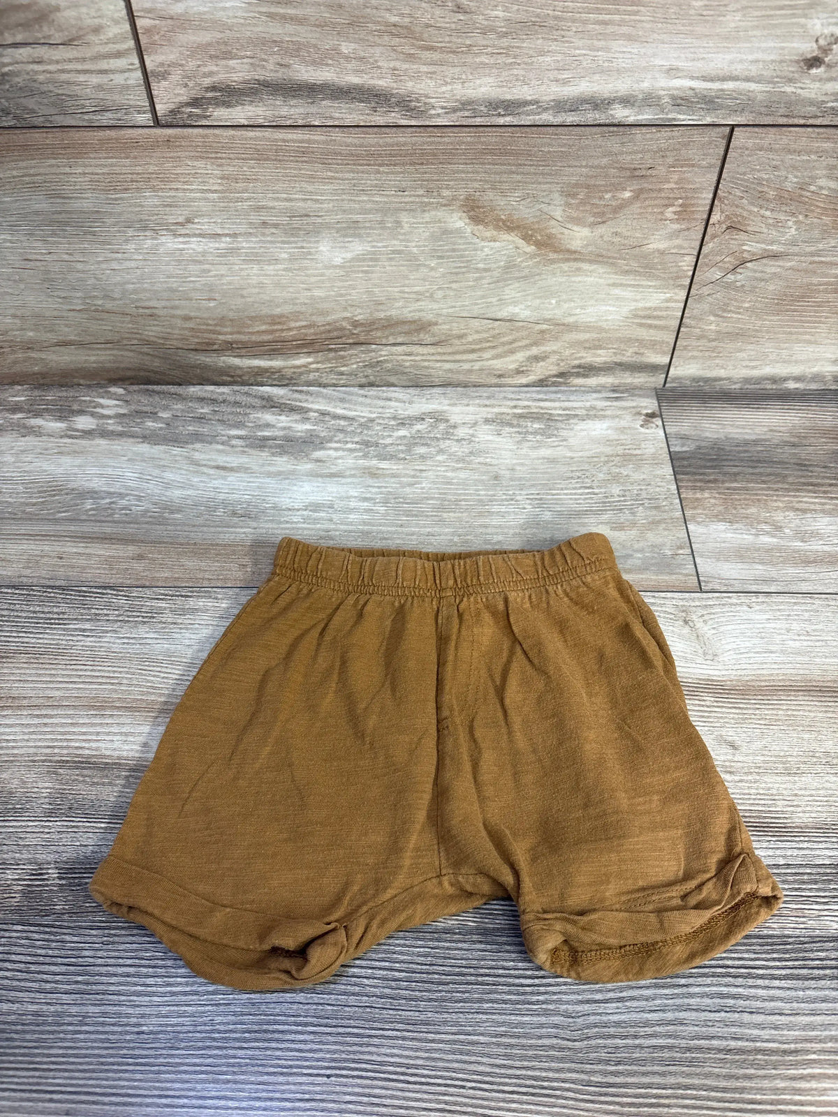 Front view of Old Navy pull-on shorts in caramel showcasing the elastic waistband and relaxed fit on a wood-look floor