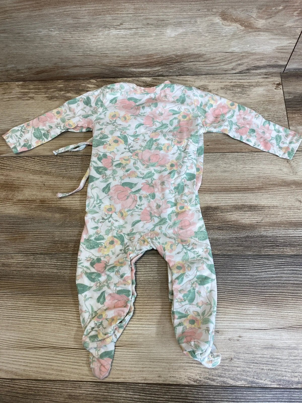 Back flat-lay of Rachel Zoe floral footed coverall, 6-9M, long sleeves, attached feet, side tie, wood floor