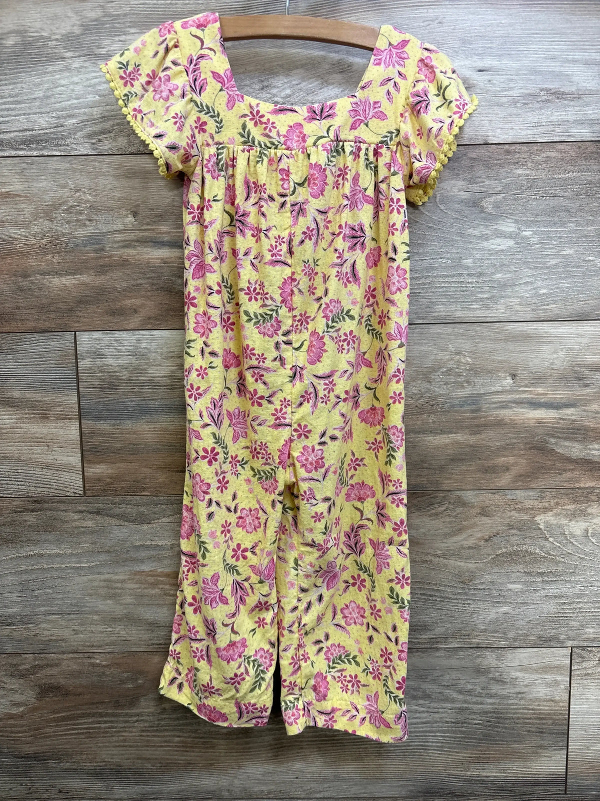 Front of Old Navy linen-blend jumpsuit, yellow floral size 3T, showing lace-trim cap sleeves and wide legs on wood background