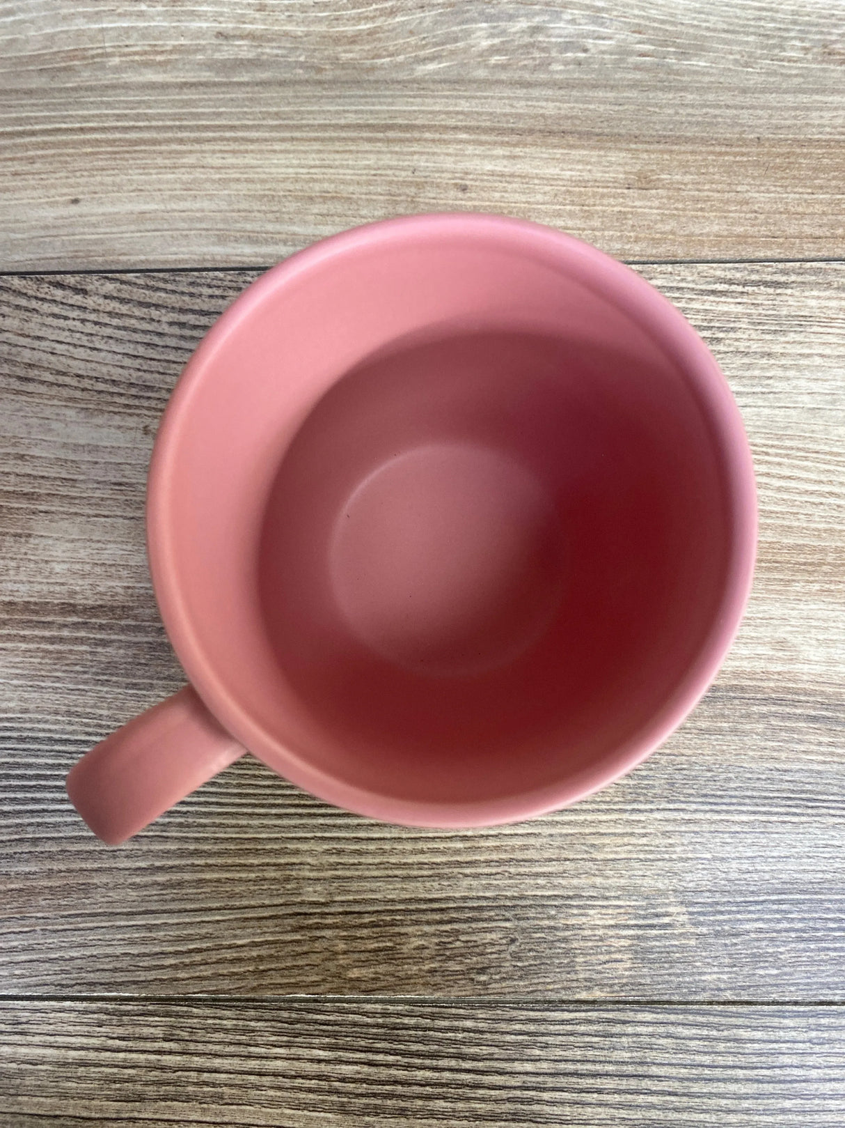 Top view of NEW Stoneware Mom Was Right About Everything Mug in pink showcasing matte exterior and glossy interior with curved handle on wood plank background