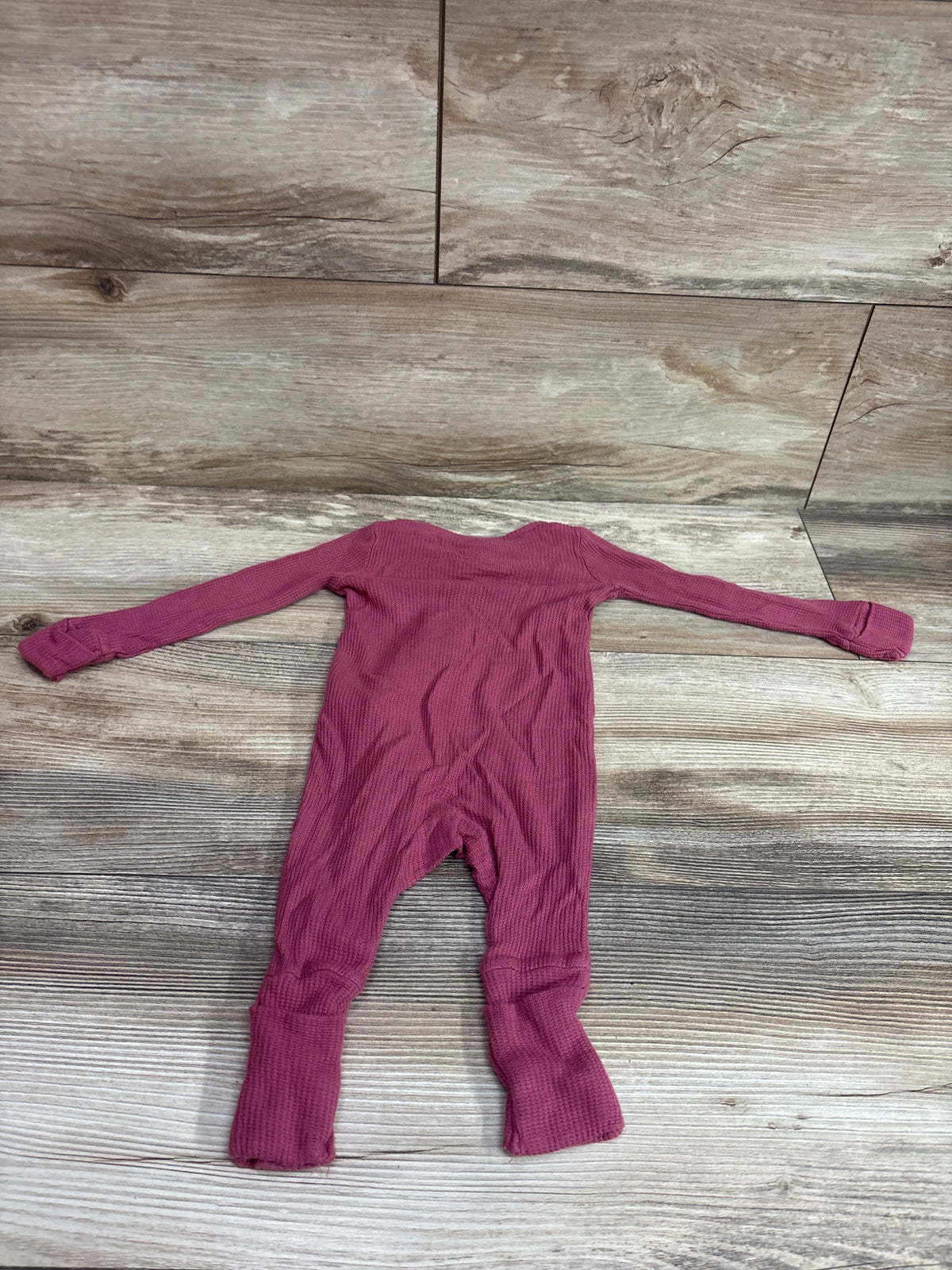 Carter's PurelySoft ribbed pink baby sleeper size 3m laid flat on a wooden background