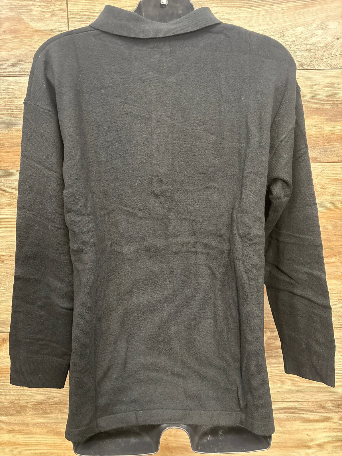 Back view of black Gap Maternity CashSoft polo sweater, size large, long-sleeve knit on mannequin against wood background