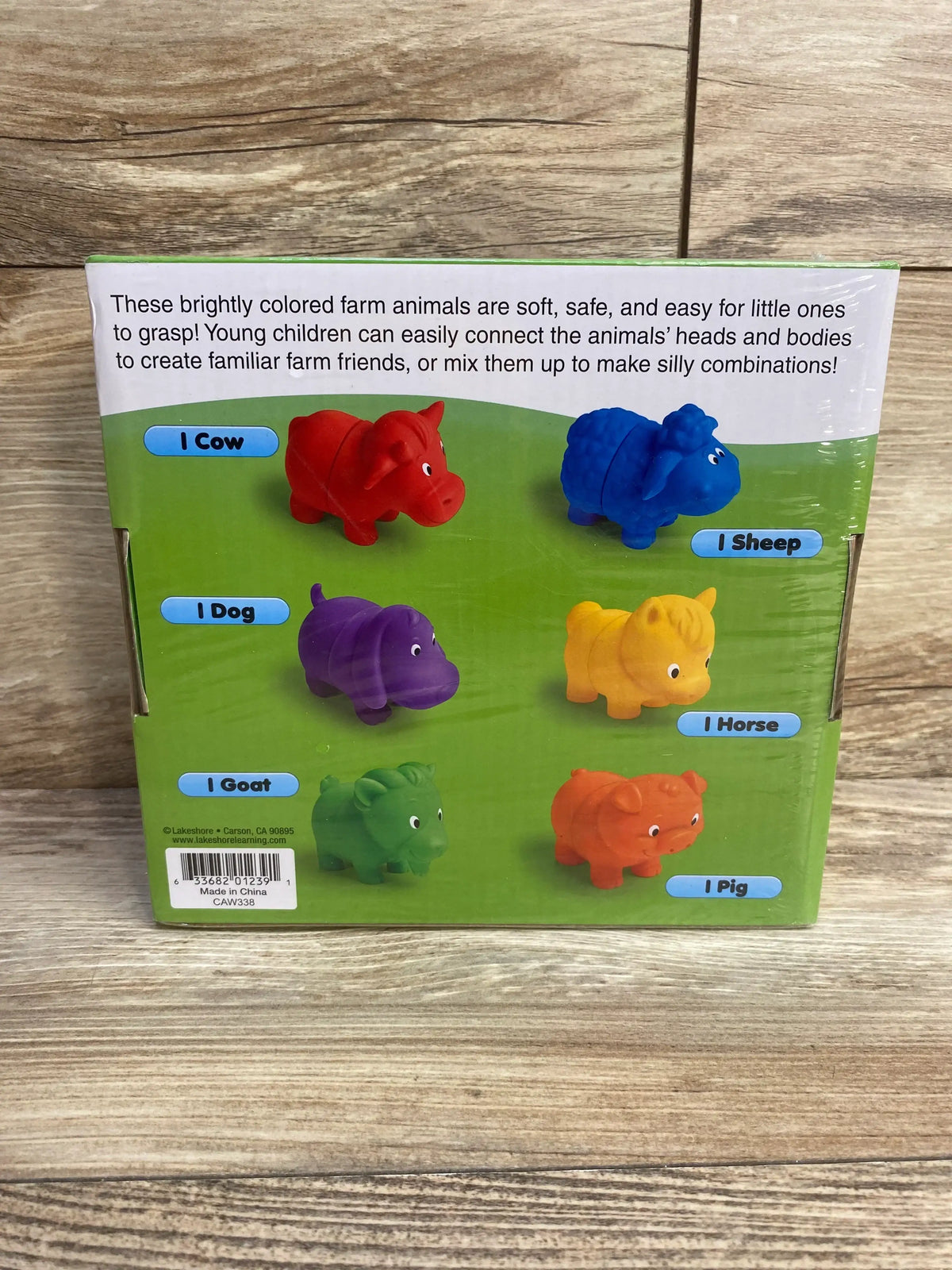 Front view of boxed Lakeshore Mix & Match Farm Animals set of 6 showing six colorful connectable animal figures with labels on wood background