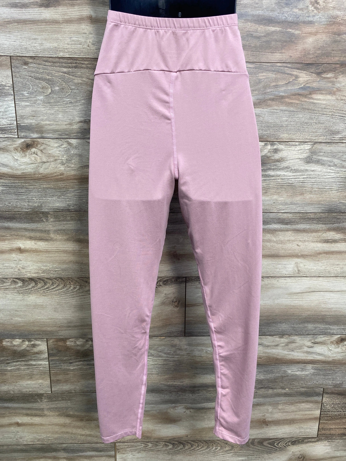 Pink high-waisted leggings on wood background, women's activewear, yoga pants