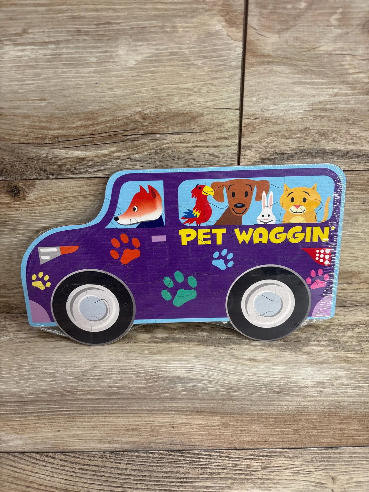 Colorful wooden pet wagon puzzle for kids with cartoon animals and paw prints on wood floor